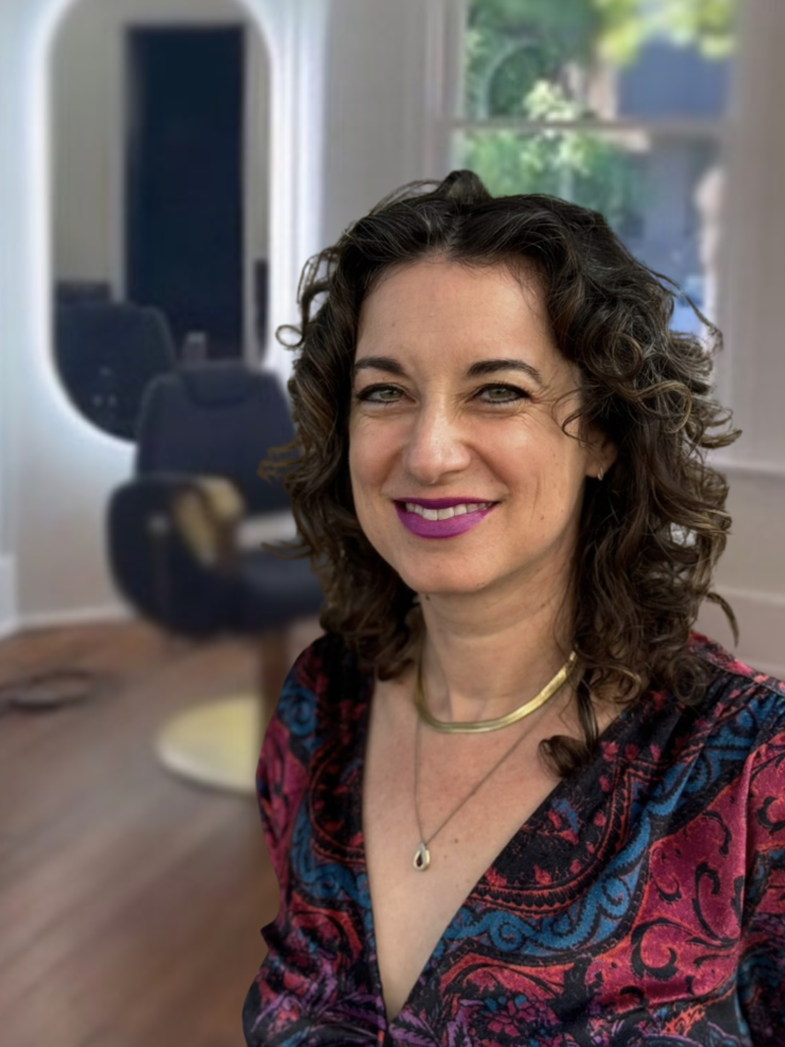 Andrea Neal-Thiesen, founder and curl specialist at Gilded Fox, smiling in the salon, Portland Oregon curly hair salon