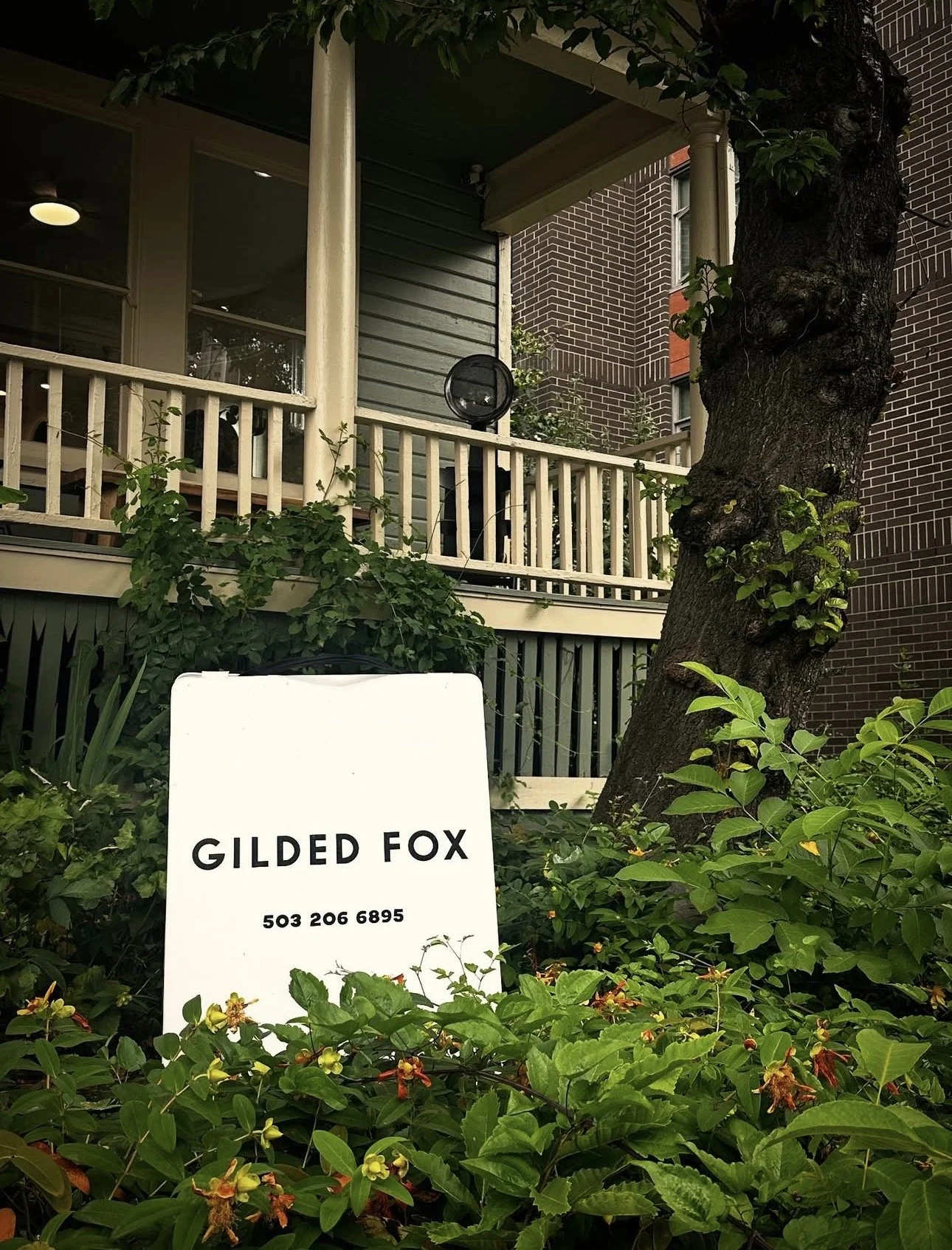 Gilded Fox curly hair salon exterior sign surrounded by greenery, Northwest Portland Oregon