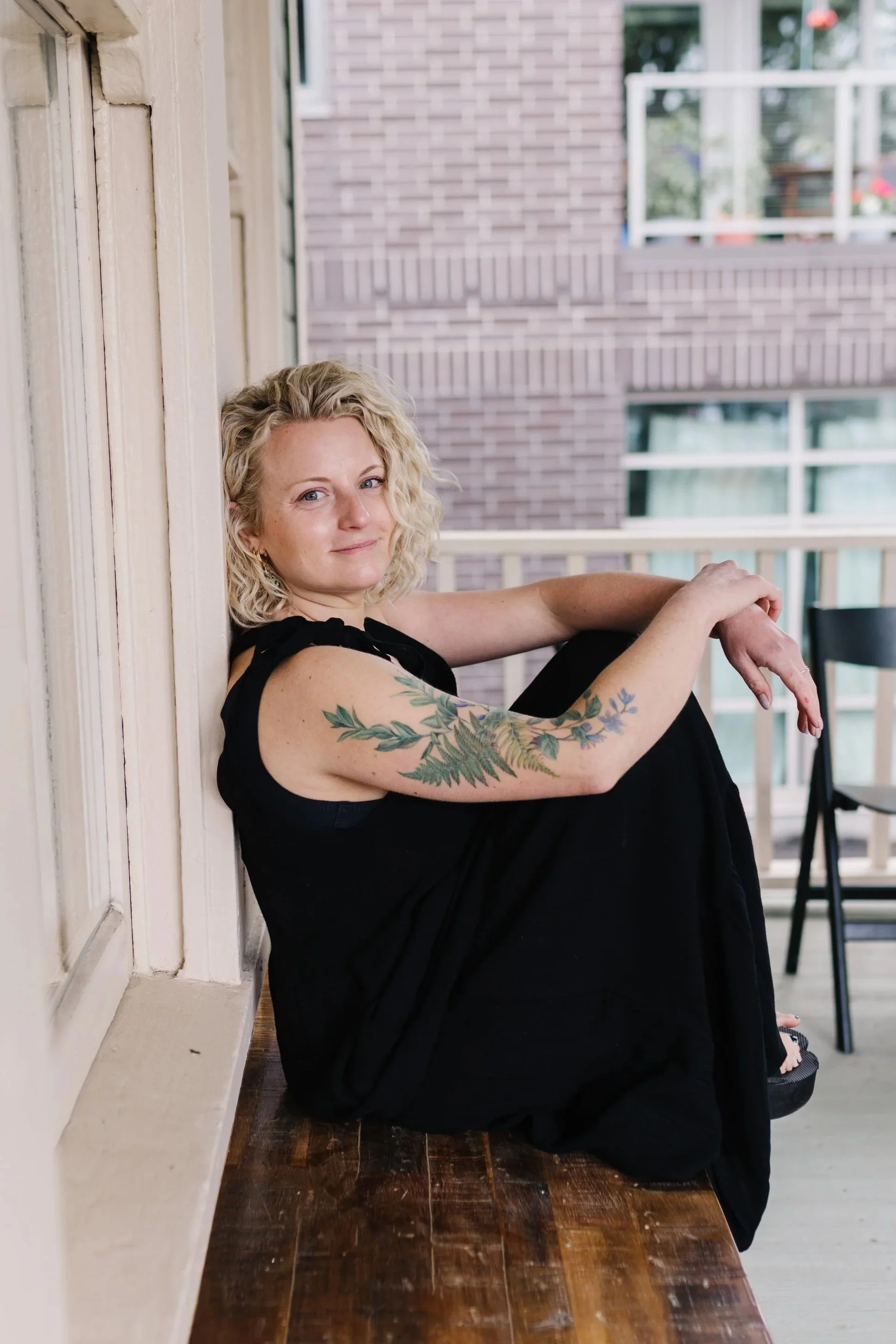 Mallory Vorhees, independent curl specialist at Gilded Fox, smiling in a casual outdoor setting, Portland Oregon curly hair salon
