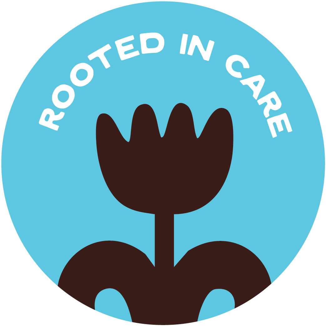 Circular badge with blue background, black tulip graphic in the center, and white text reading 'ROOTTED IN CARE' curved around the top.