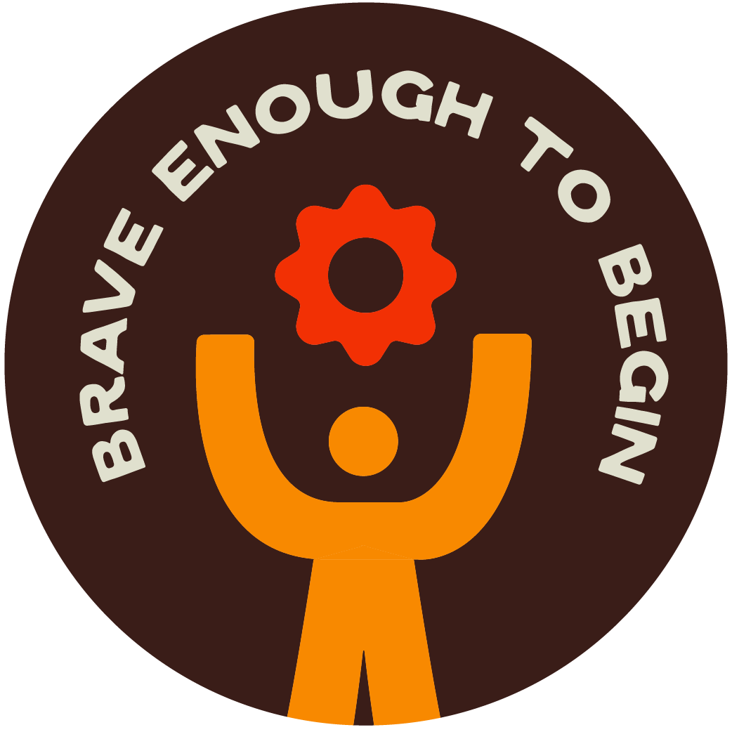 A circular logo with orange and brown colors featuring a stylized person with arms raised, holding a red gear above their head. The text around the circle reads, "BRAVE ENOUGH TO BE YOURSELF."