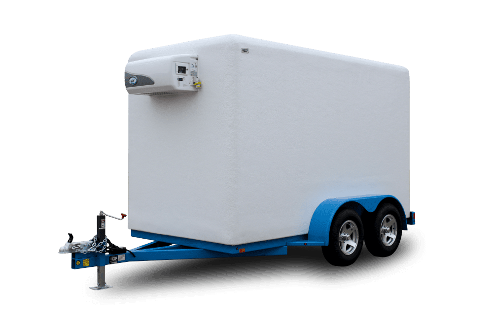 White mobile trailer with blue trim and dual axles, attached to a hitch, with a small device on the front, against a black background.