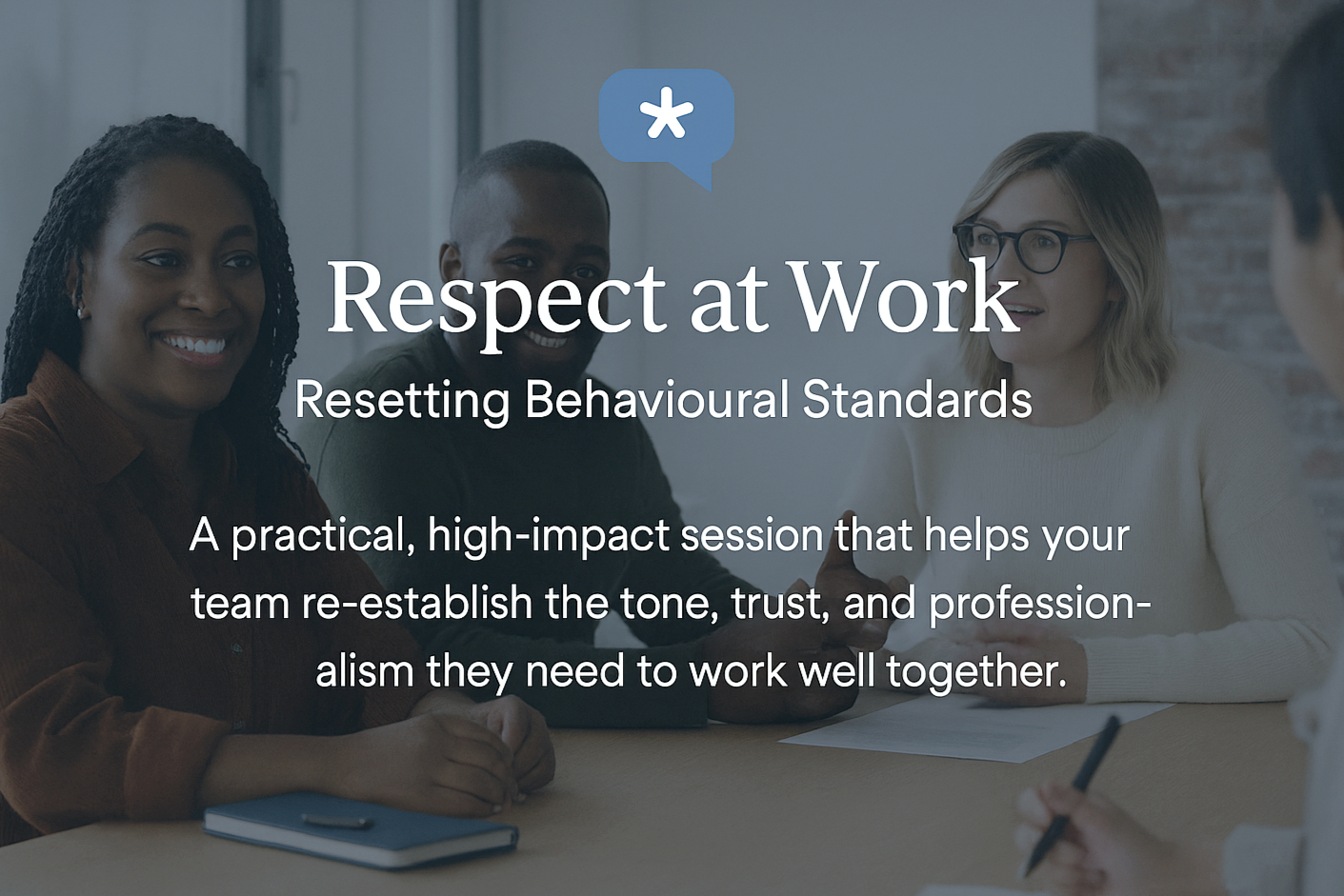 Group of diverse colleagues smiling and engaging in a professional discussion during a work meeting.