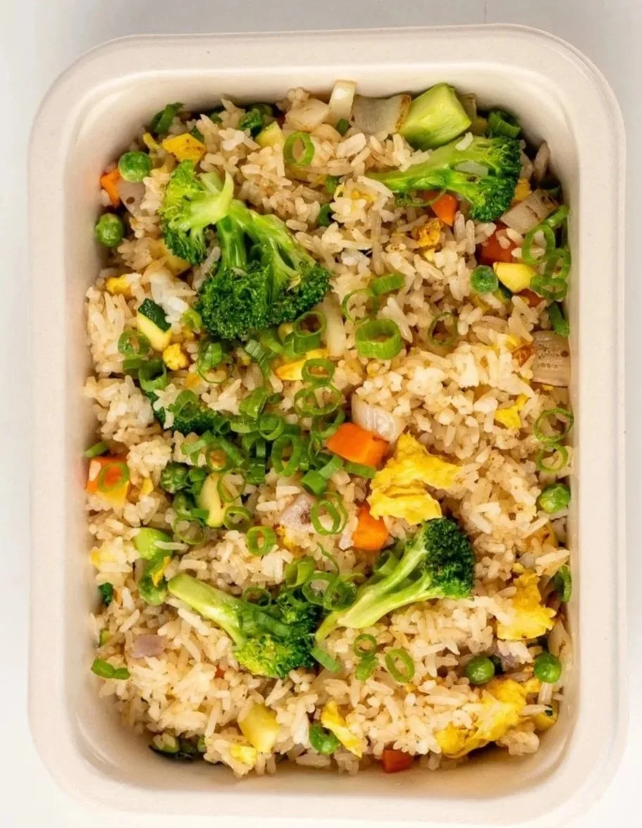 Vegetable fried rice with broccoli, peas, carrots, scrambled eggs, and chopped green onions.