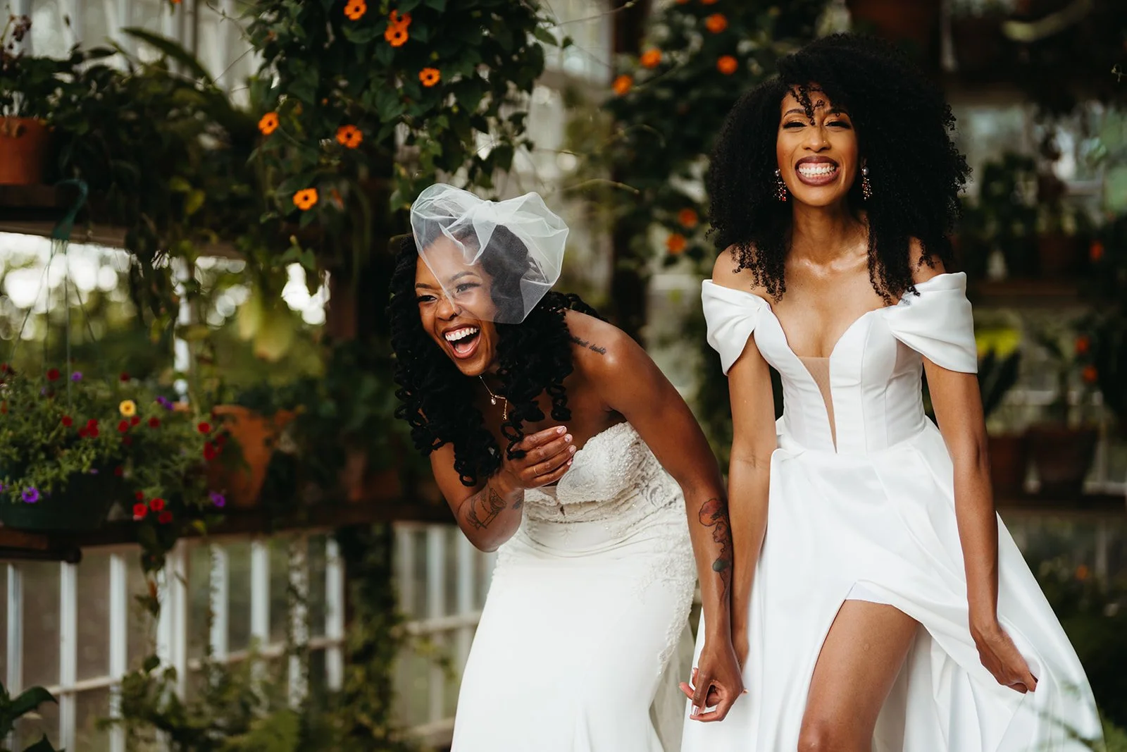 Two brides share laughter as they walk down the aisle