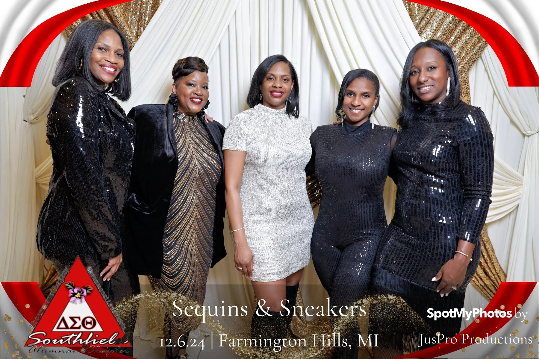 Group of five women dressed in black and silver formal attire at a sorority event in front of a decorated backdrop.