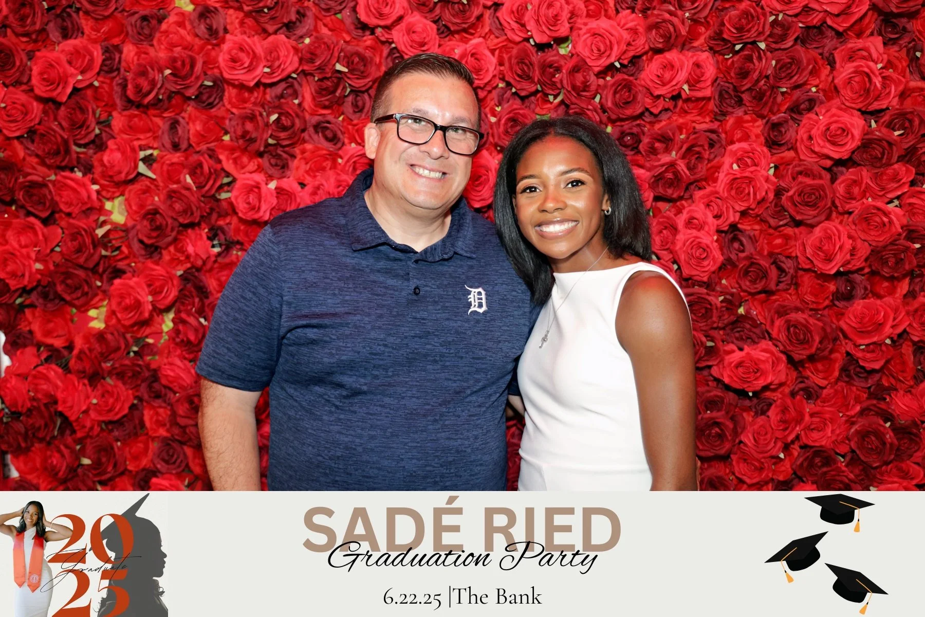 A smiling man and woman stand in front of a backdrop filled with red roses at a graduation party. The man wears glasses and a blue polo shirt, and the woman wears a white sleeveless dress. The bottom of the image features a graduation-themed banner with the text "SADÉ RIED Graduation Party" and the date "6.22.25".