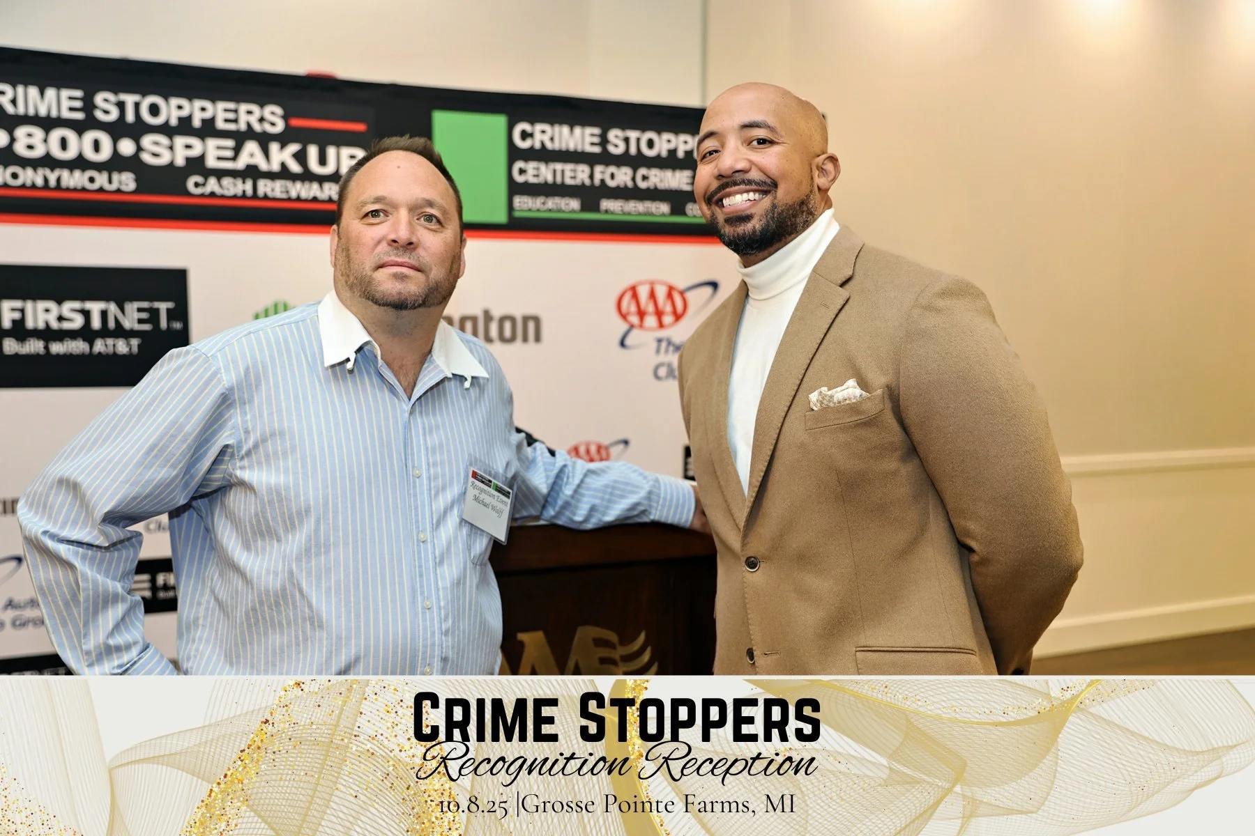 Two men standing together at the Crime Stoppers Recognition Reception, smiling for the photo, with a banner in the background displaying Crime Stoppers sponsorship logos, at Grosse Pointe Farms, Michigan, on October 8, 2025.