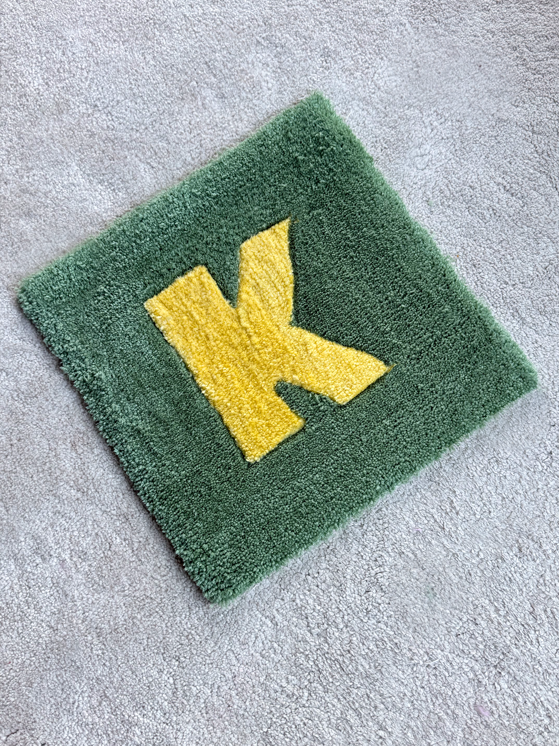 K neura letter rug.png
