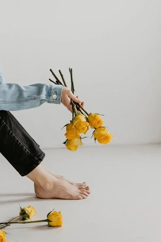 Brand photo of Kirsten Johnson, Founder at Reverie Creative Agency in Arizona holding some flowers.