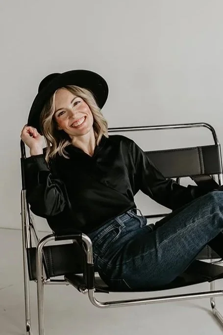Brand photo of Kirsten Johnson, Founder at Reverie Creative Agency in Arizona sitting in a chair.