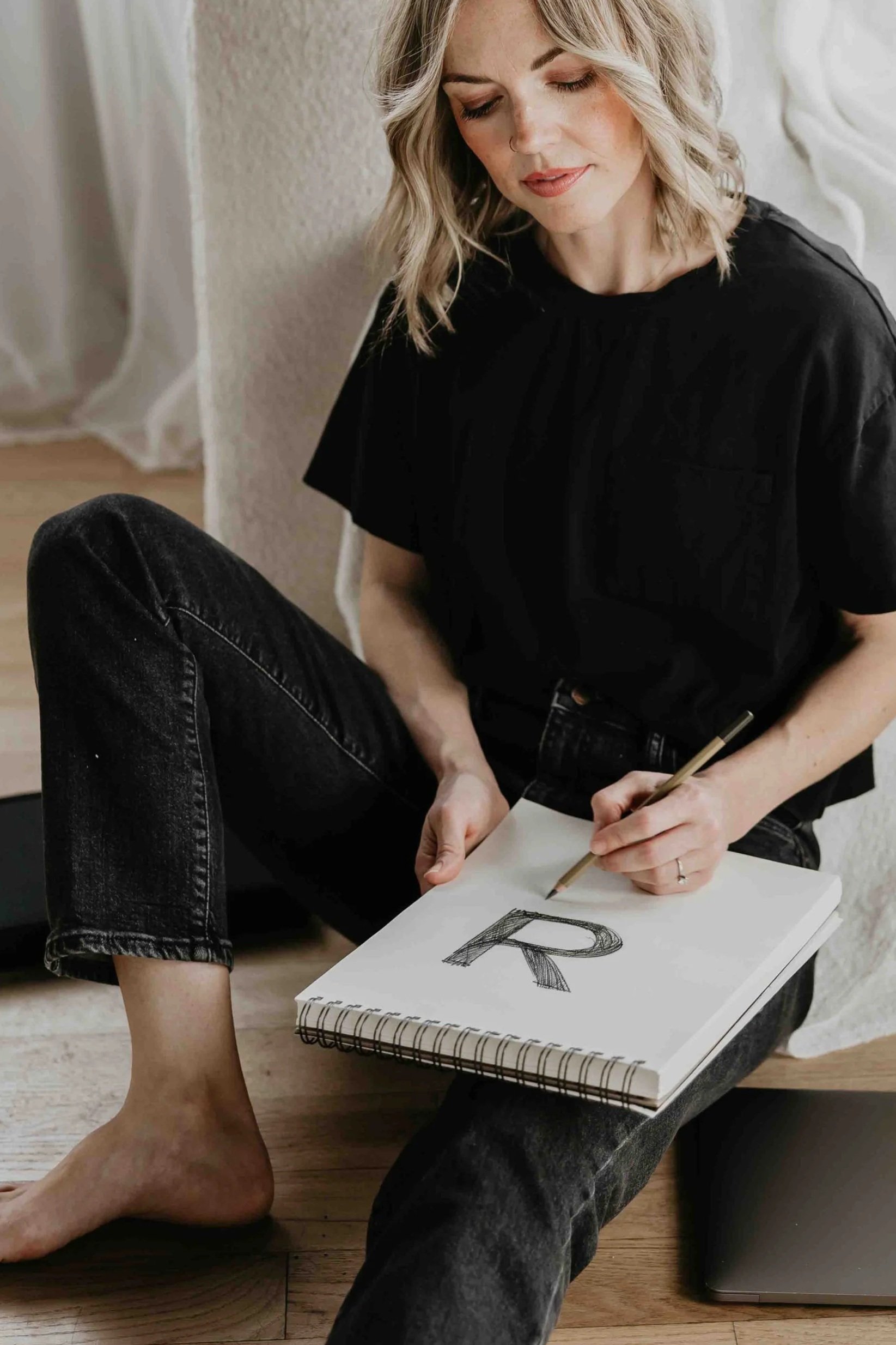Brand photo of Kirsten Johnson, founder of Reverie Creative Agency in Arizona sketching a logo.
