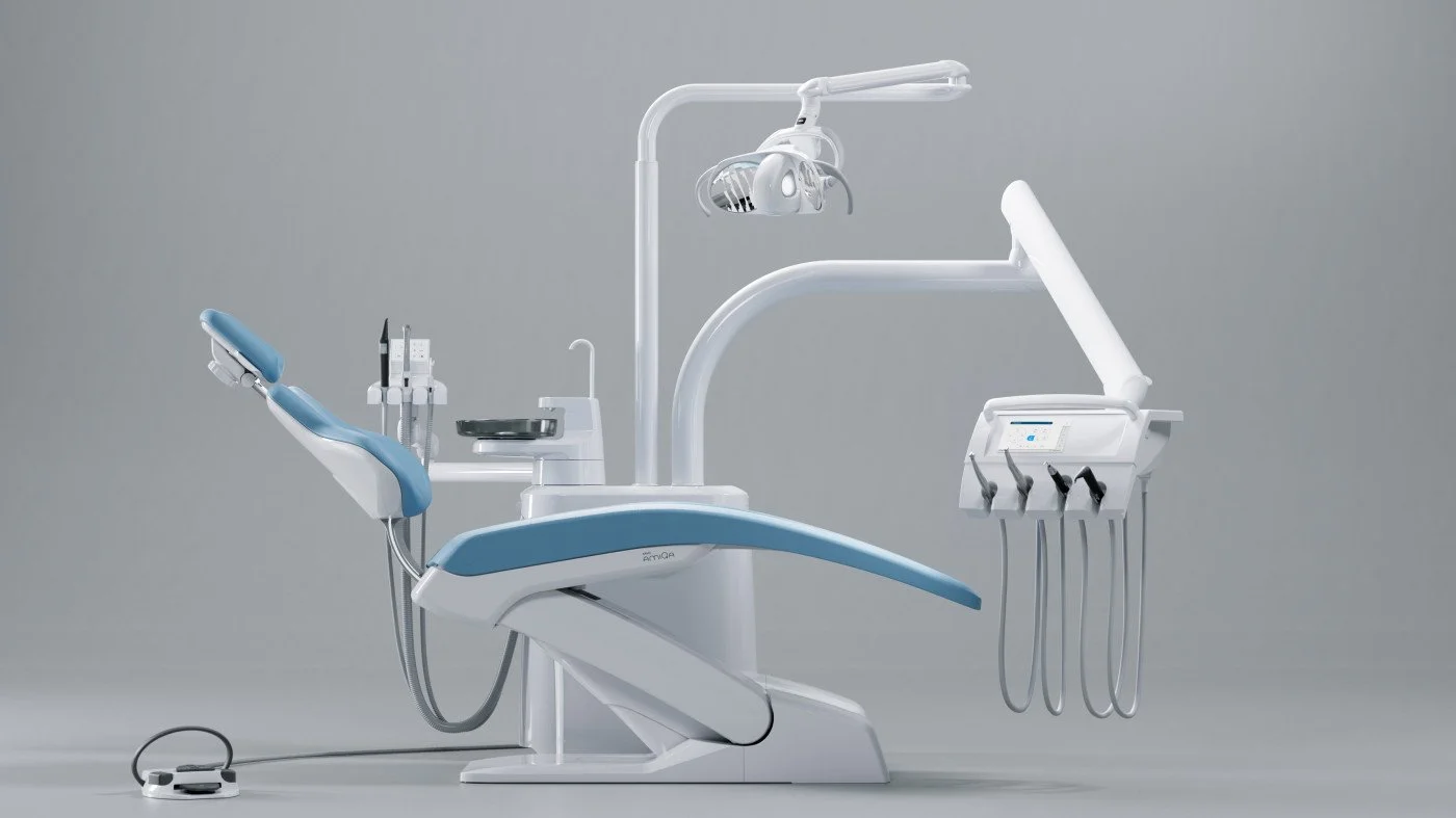 Modern dental chair with attached dental tools and equipment in a clinical setting