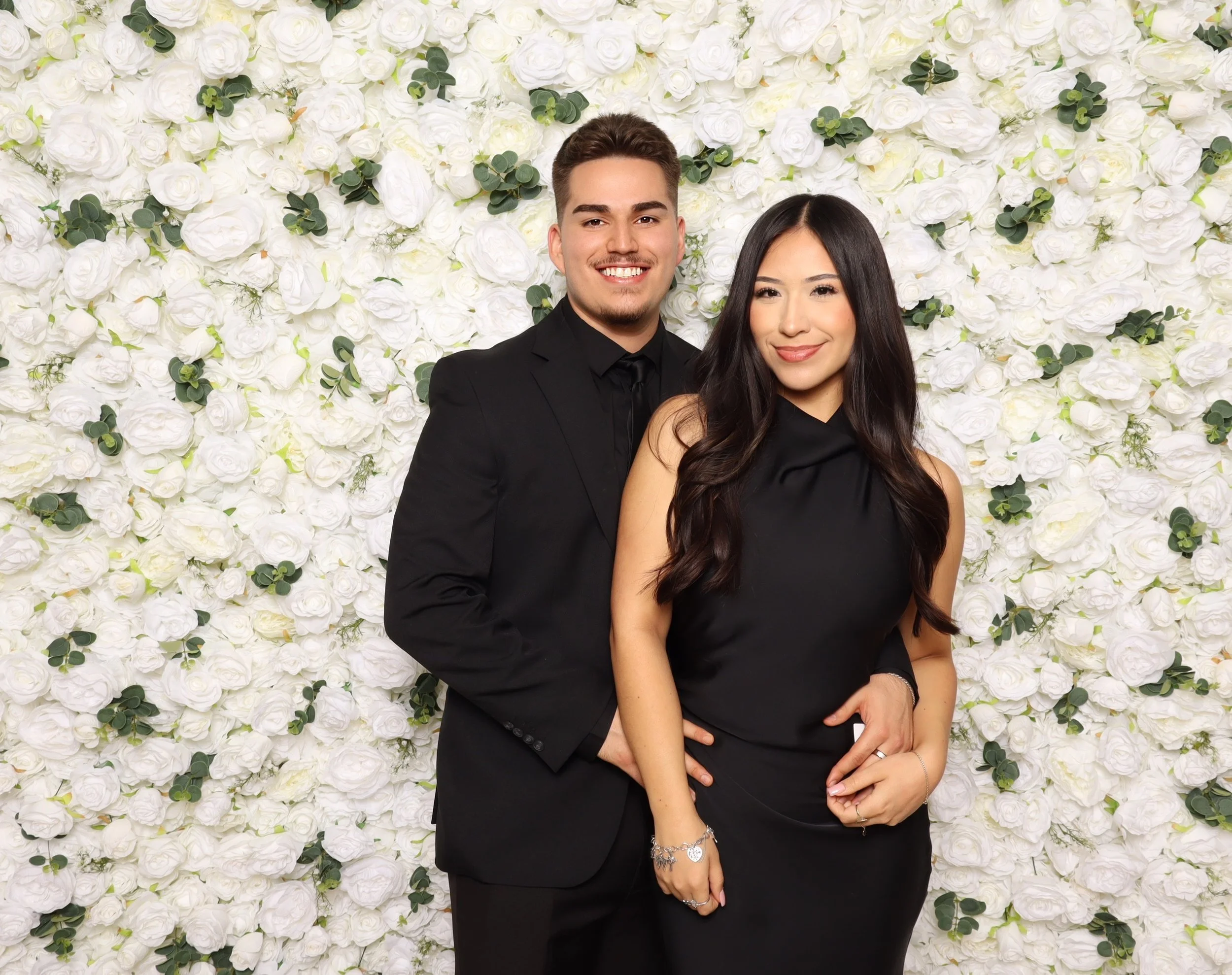 Luxury photo booth experience at a DFW black-tie charity gala with elegant floral backdrop