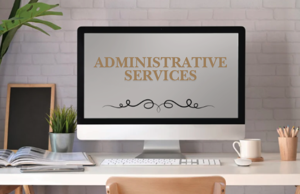 Computer monitor displaying 'Administrative Services' with a desk setup including a chalkboard, plant, open notebook, mug, and pens.