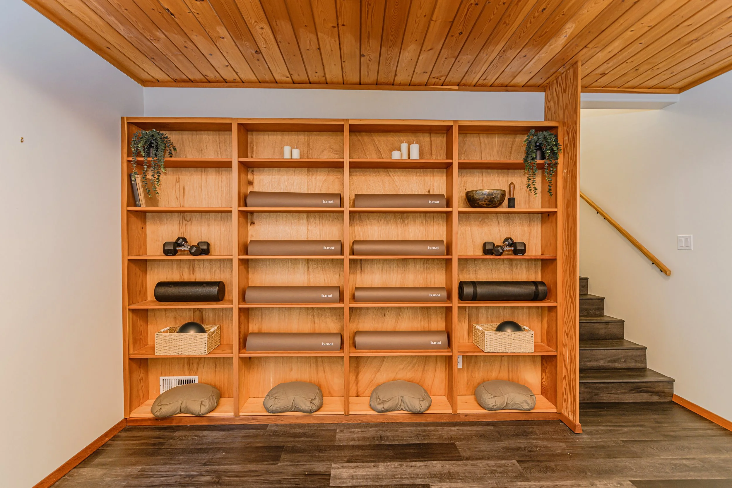 shelve of yoga pillows and bmats