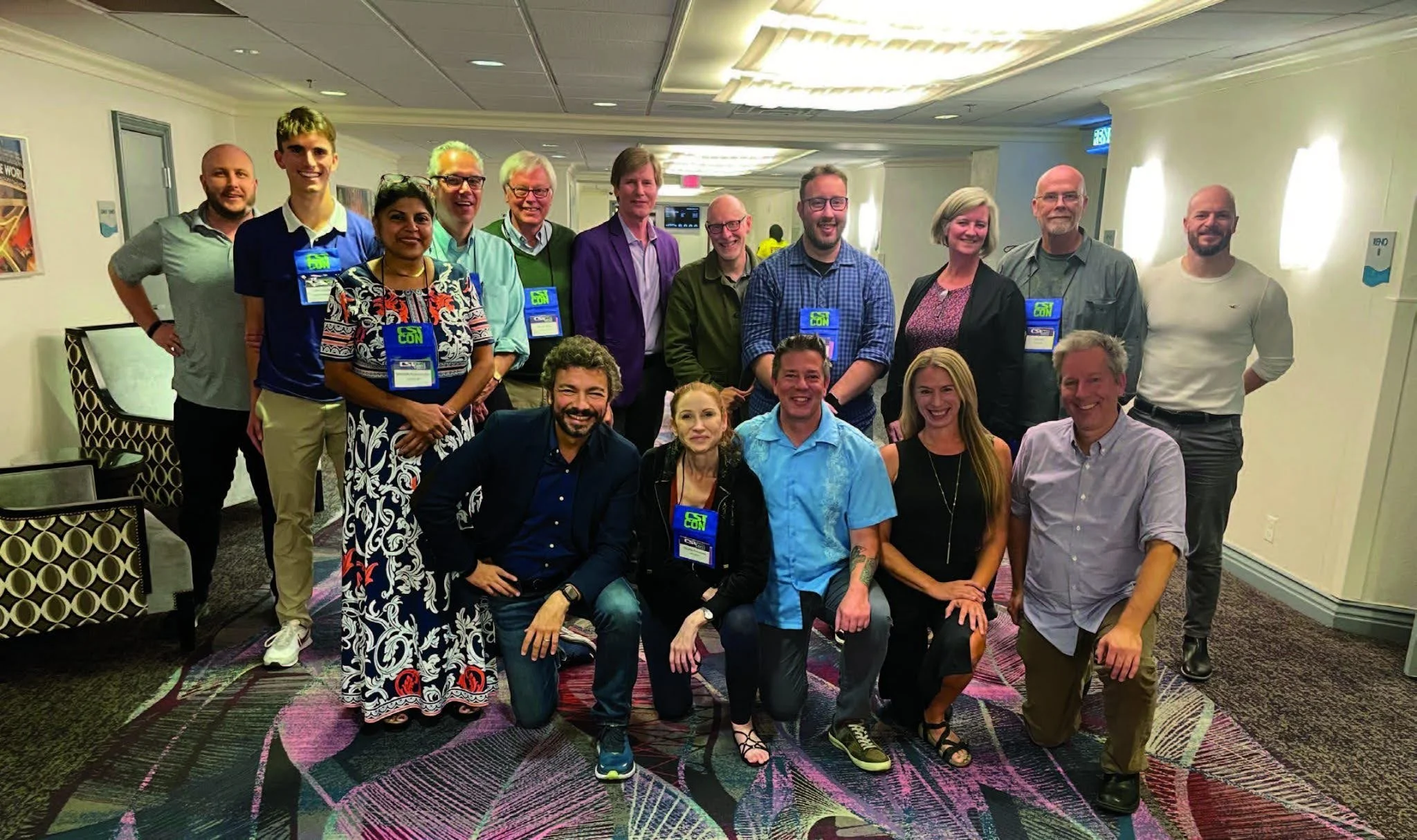 Group of people from the 2022 meeting of the Lilienfeld Alliance at a conference, all smiling, some wearing conference badges.