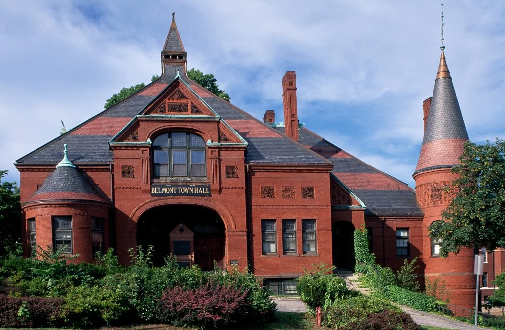 Red brick Victorian-style building with turrets, labeled as Belmont Town Hall.