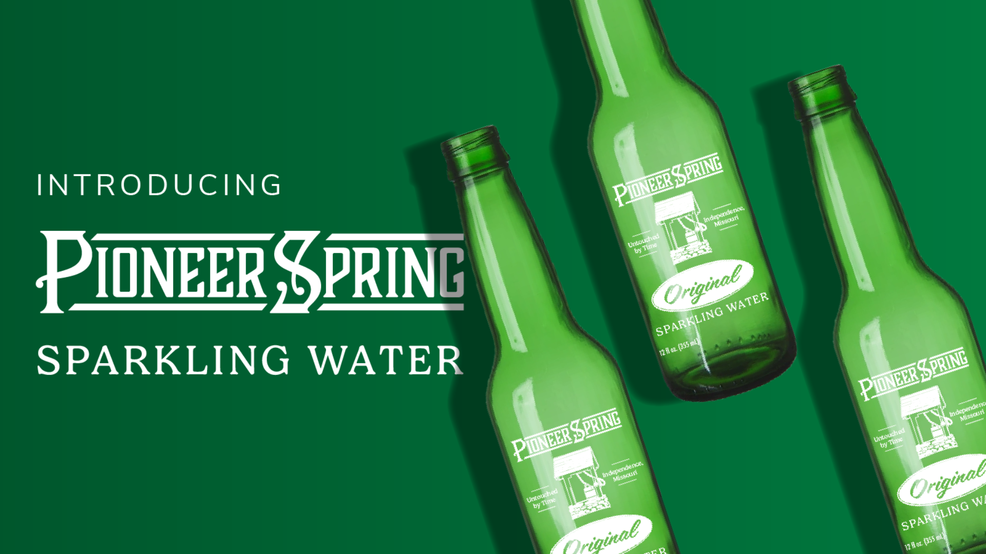Green glass bottles with Pioneer Spring Sparkling Water logos on them.