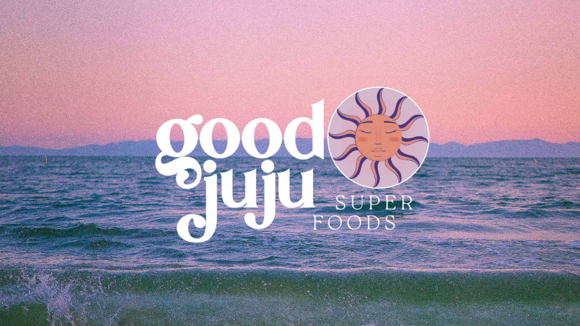 Good JuJu Superfoods logo of fun font and a funky sun superimposed on a photo of a beach at sunset.