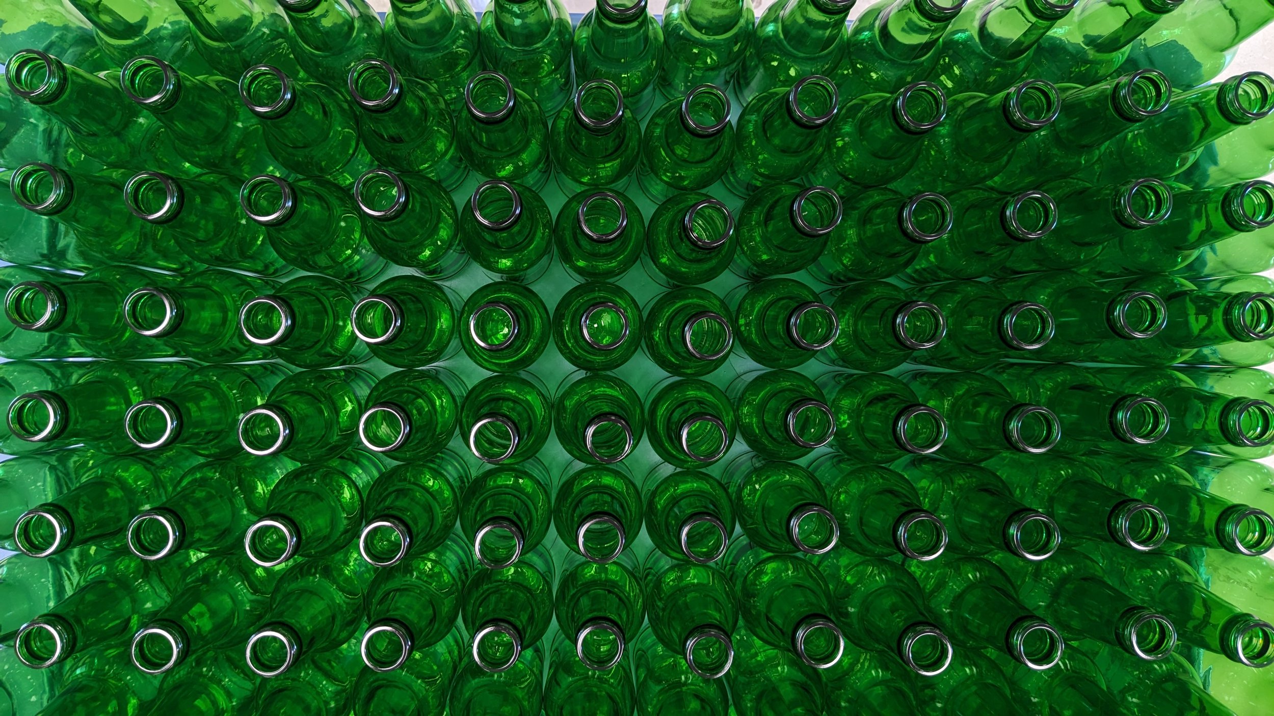 Overhead view of green glass bottles.