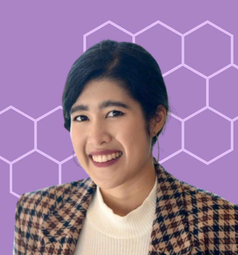A woman with black hair smiling, wearing a beige and black checkered blazer and white turtleneck, set against a purple background with white hexagonal pattern.
