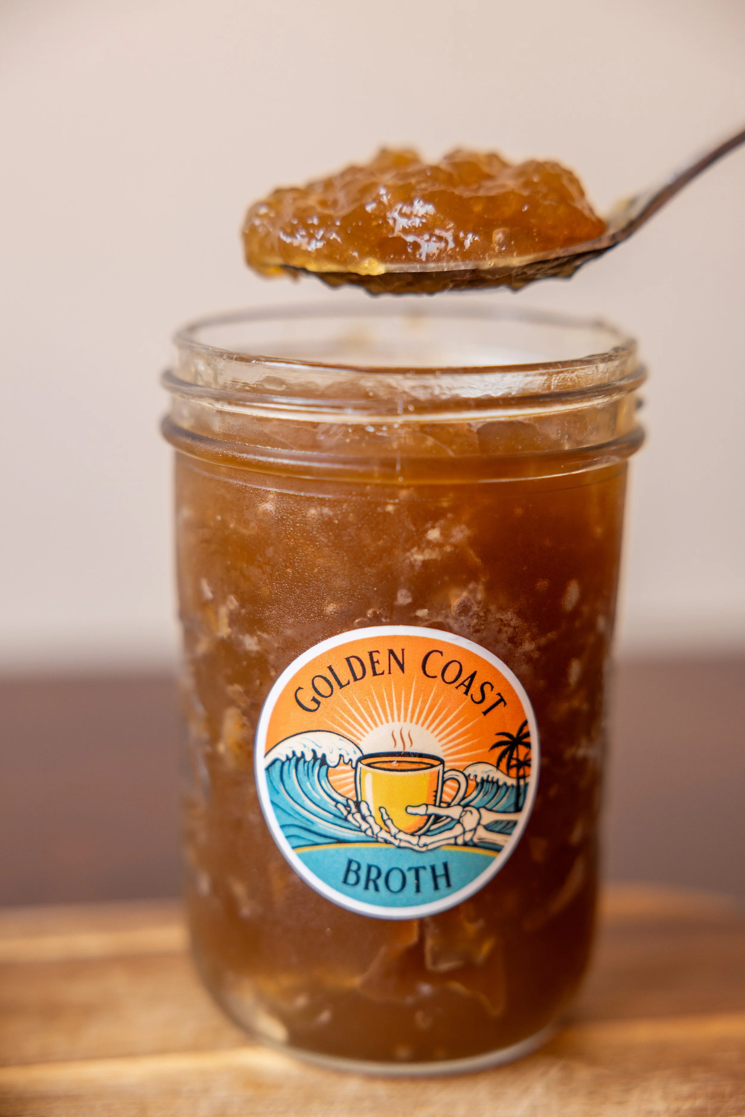 Close up of Golden Coast bone broth showing thick, gelatinous collagen texture.