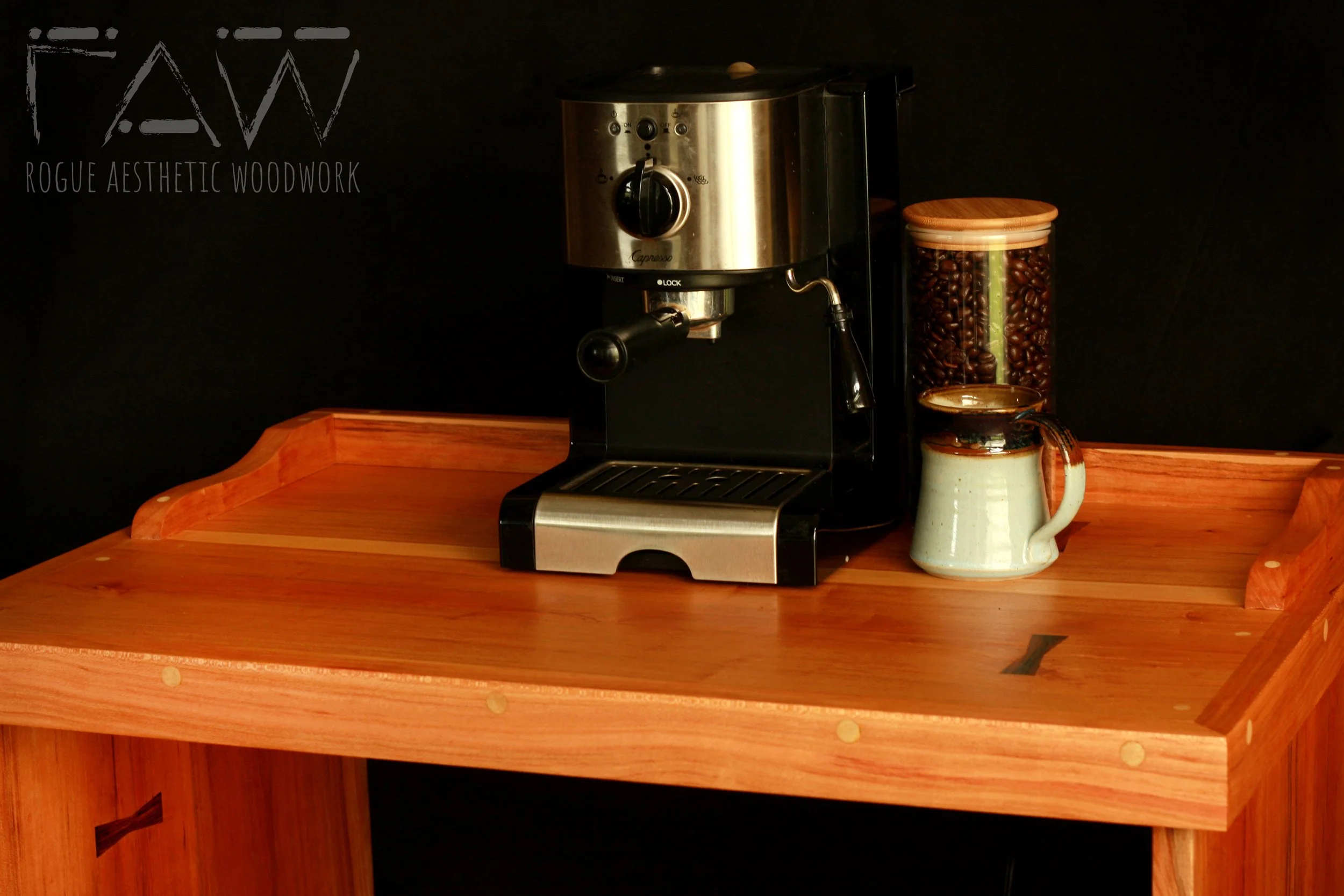 solid cherry hardwood coffee stand with shaker style cabinet doors and a low hand shaped curved rail — bespoke furniture by Rogue Aesthetic Woodwork, High Springs FL in use