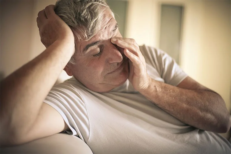 Man experiencing daytime fatigue and exhaustion caused by untreated sleep apnea for Northwest Ohio Sleep Solutions in Maumee Ohio