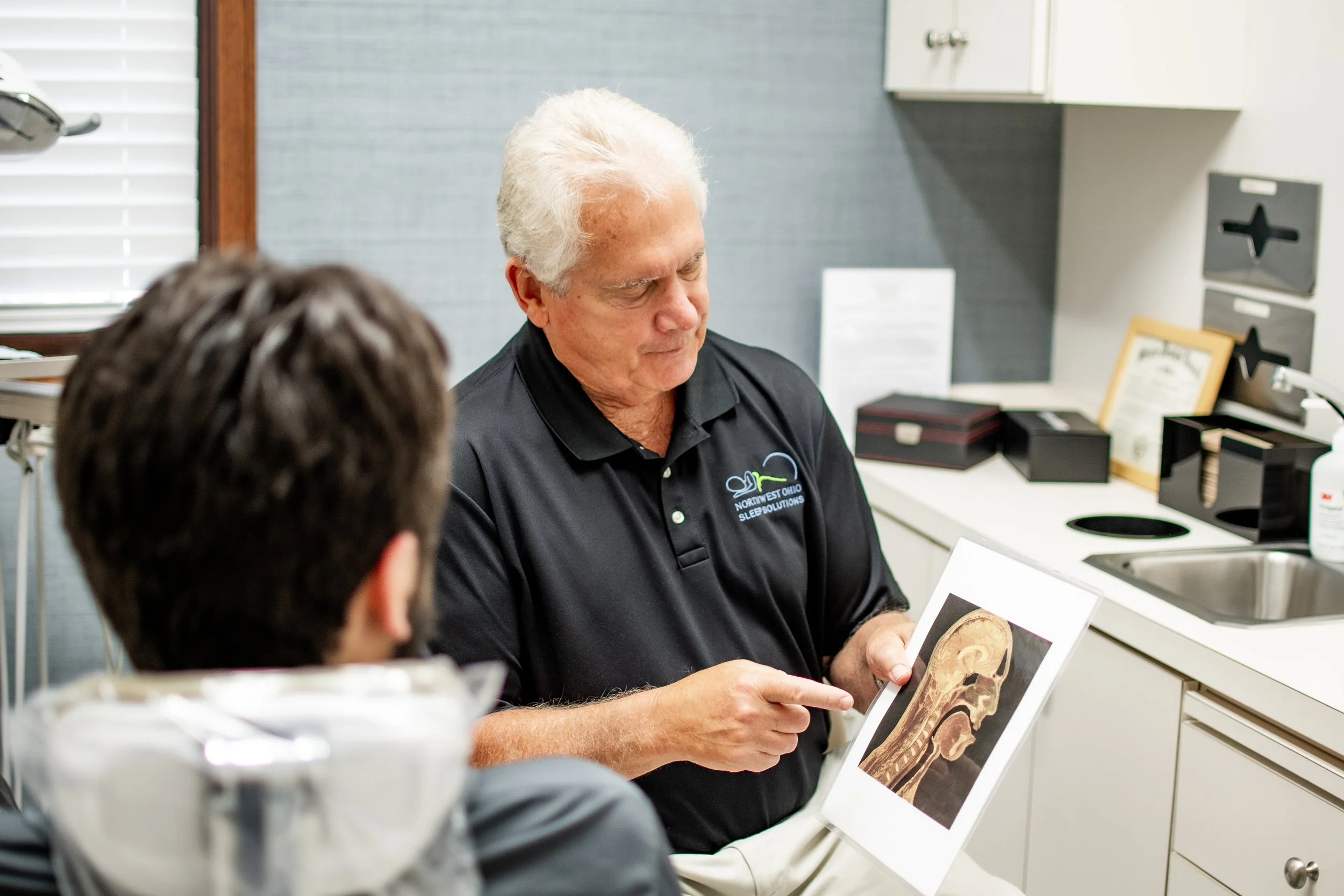 Dr. Stuckey at Northwest Ohio Sleep Solutions in Maumee, Ohio explaining obstructive sleep apnea anatomy to a patient during a consultation