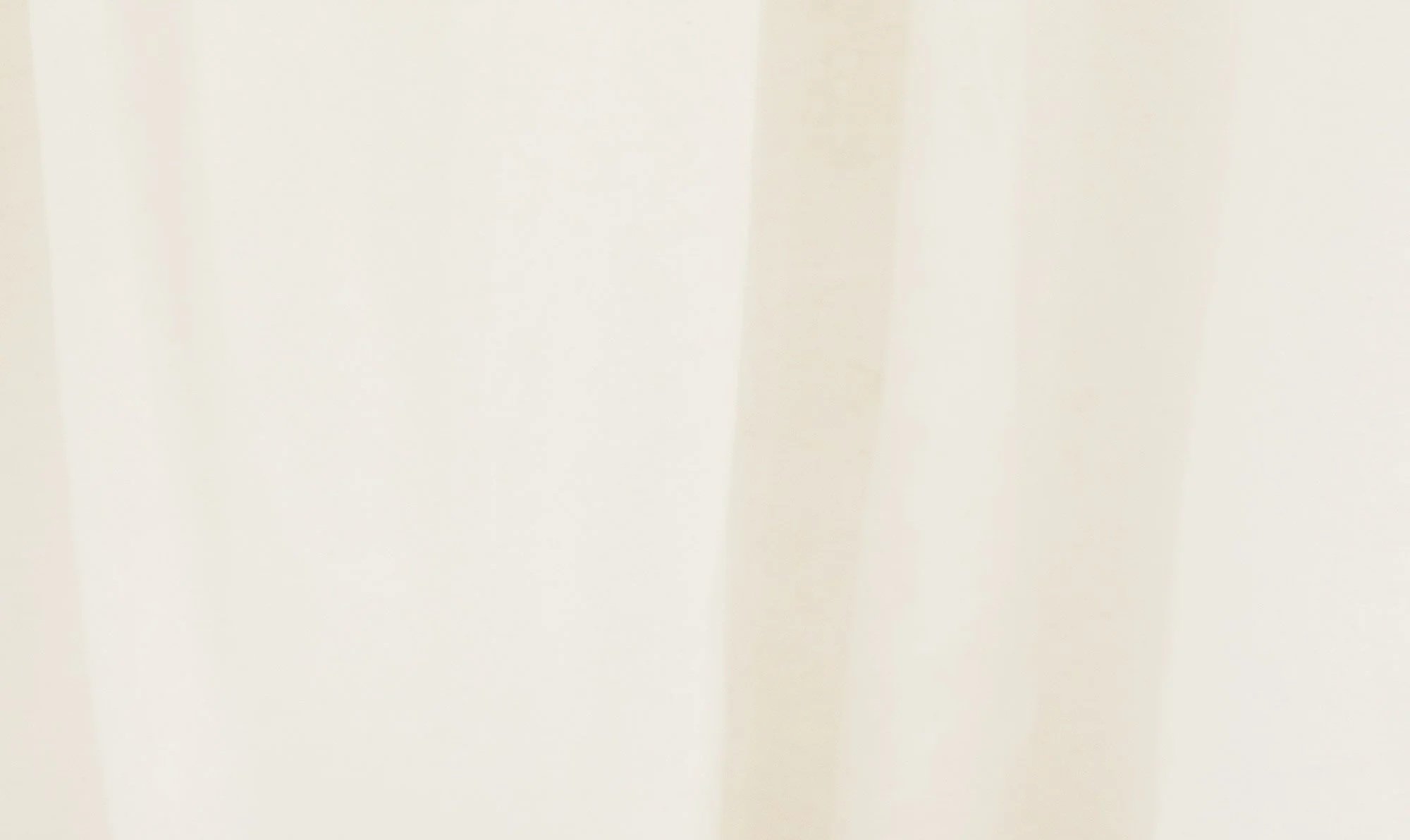 A close-up of a plain white surface, possibly a wall or sheet of paper.