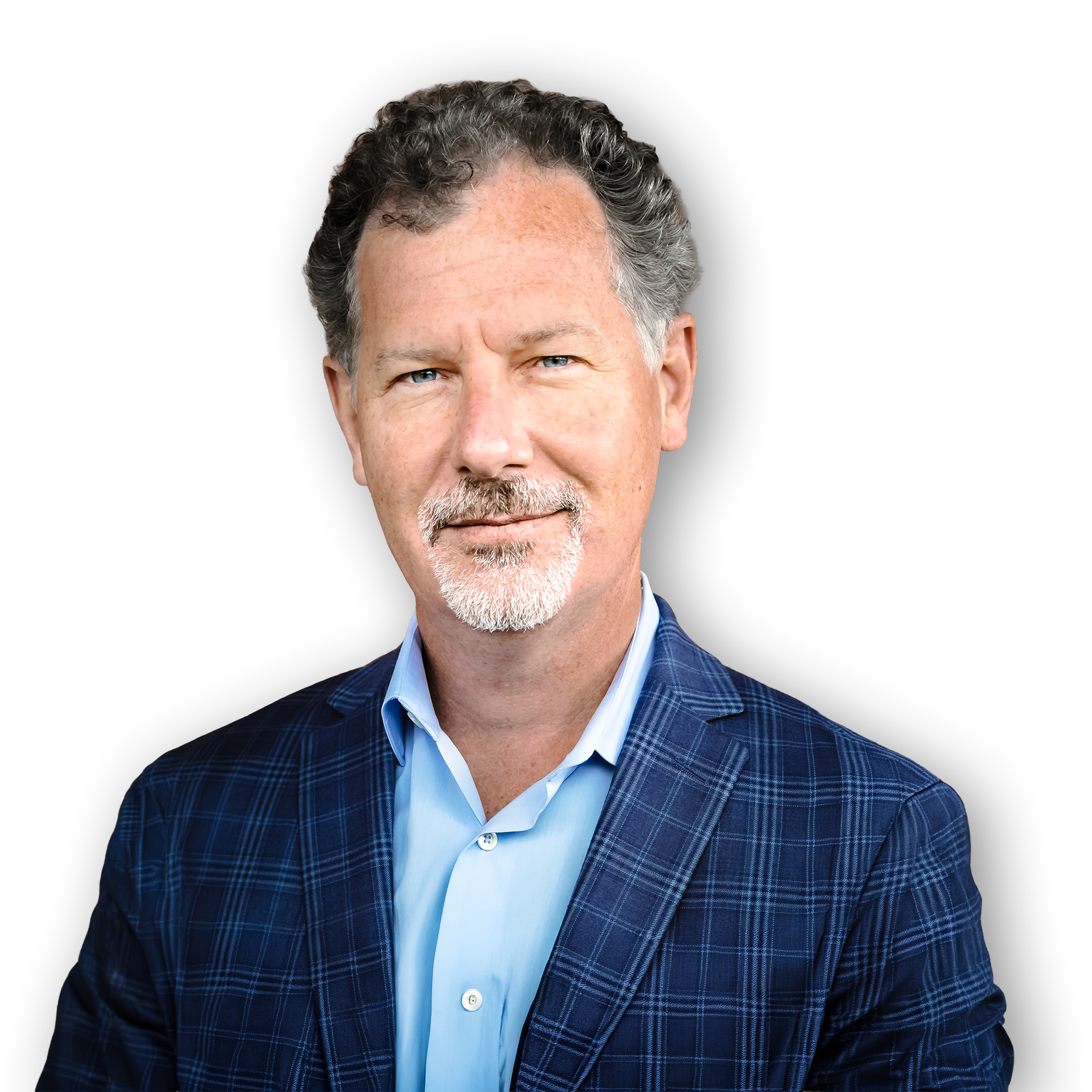 Close-up of a middle-aged man with blue eyes, curly salt-and-pepper hair, and a short beard, wearing a blue dress shirt and a dark blue plaid blazer, against a solid black background.