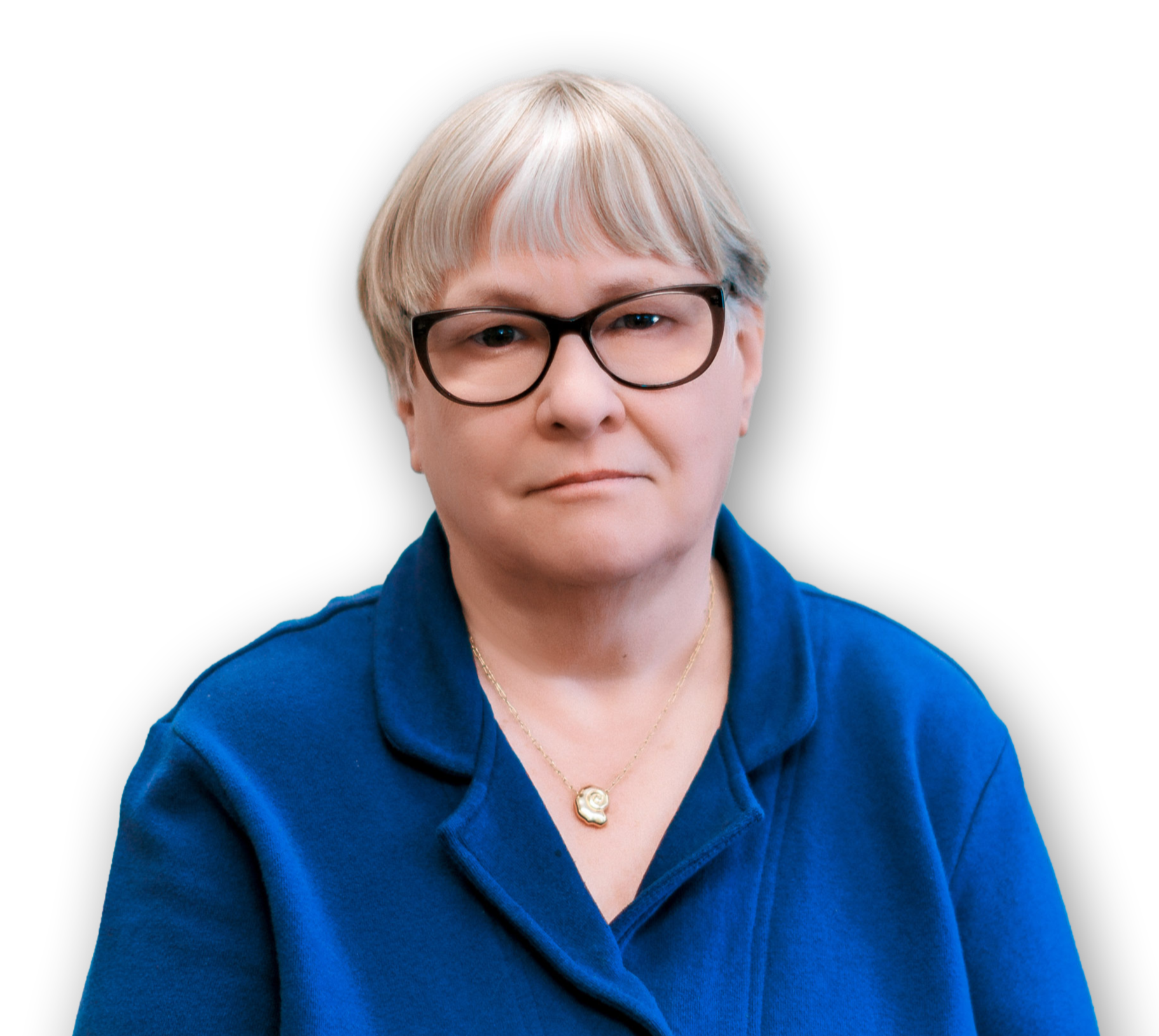 A middle-aged woman with short, light blonde hair and glasses, wearing a blue shirt, a gold necklace with a spiral pendant, and a slight smile, against a black background.