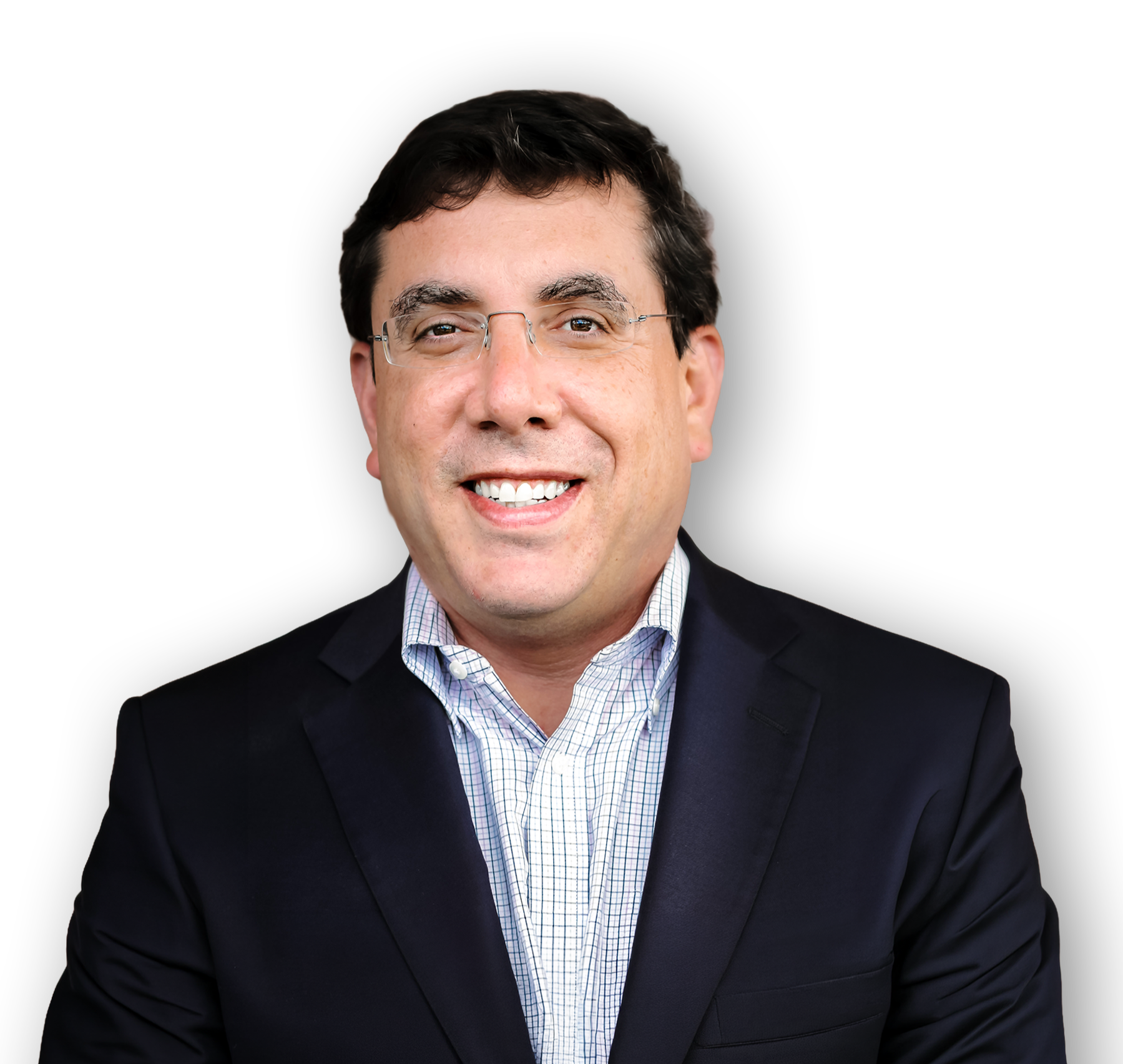Portrait of a smiling man wearing glasses, a dark blazer, and a checkered dress shirt against a black background.