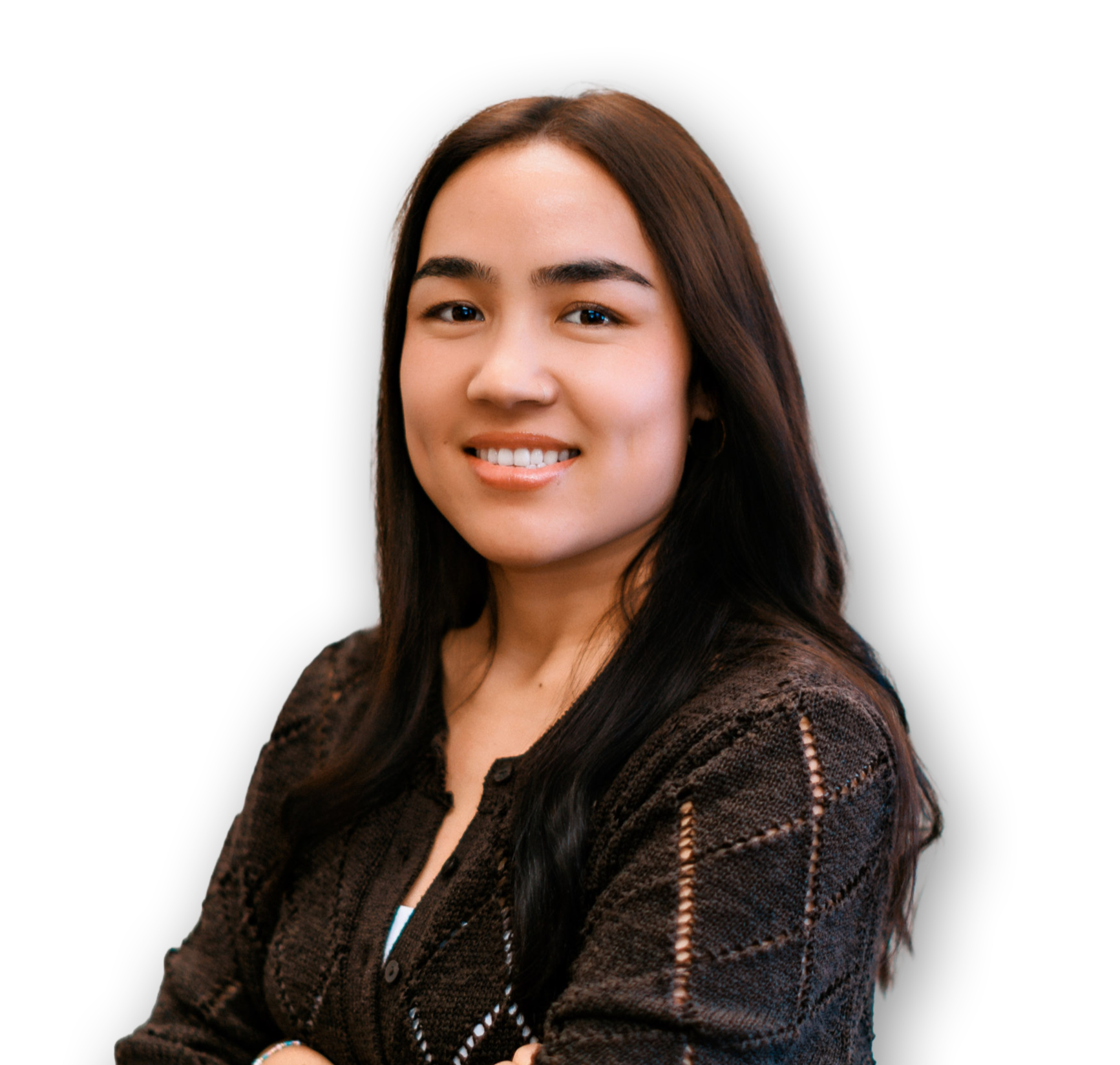A young woman with long dark hair, smiling, wearing a dark brown knitted jacket, posing against a black background.