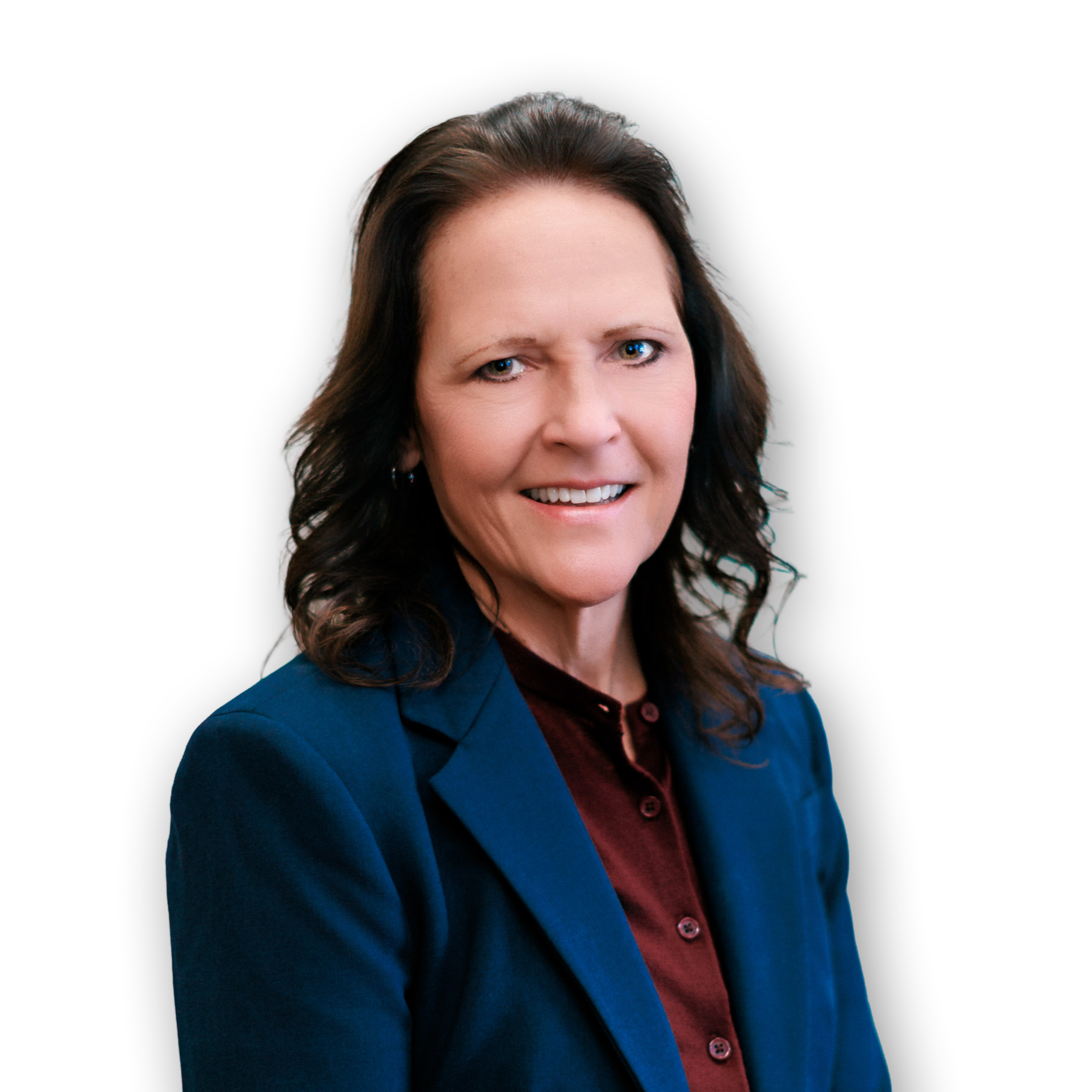 Close-up of a woman with brown hair wearing a dark red shirt and a blue blazer, against a black background.