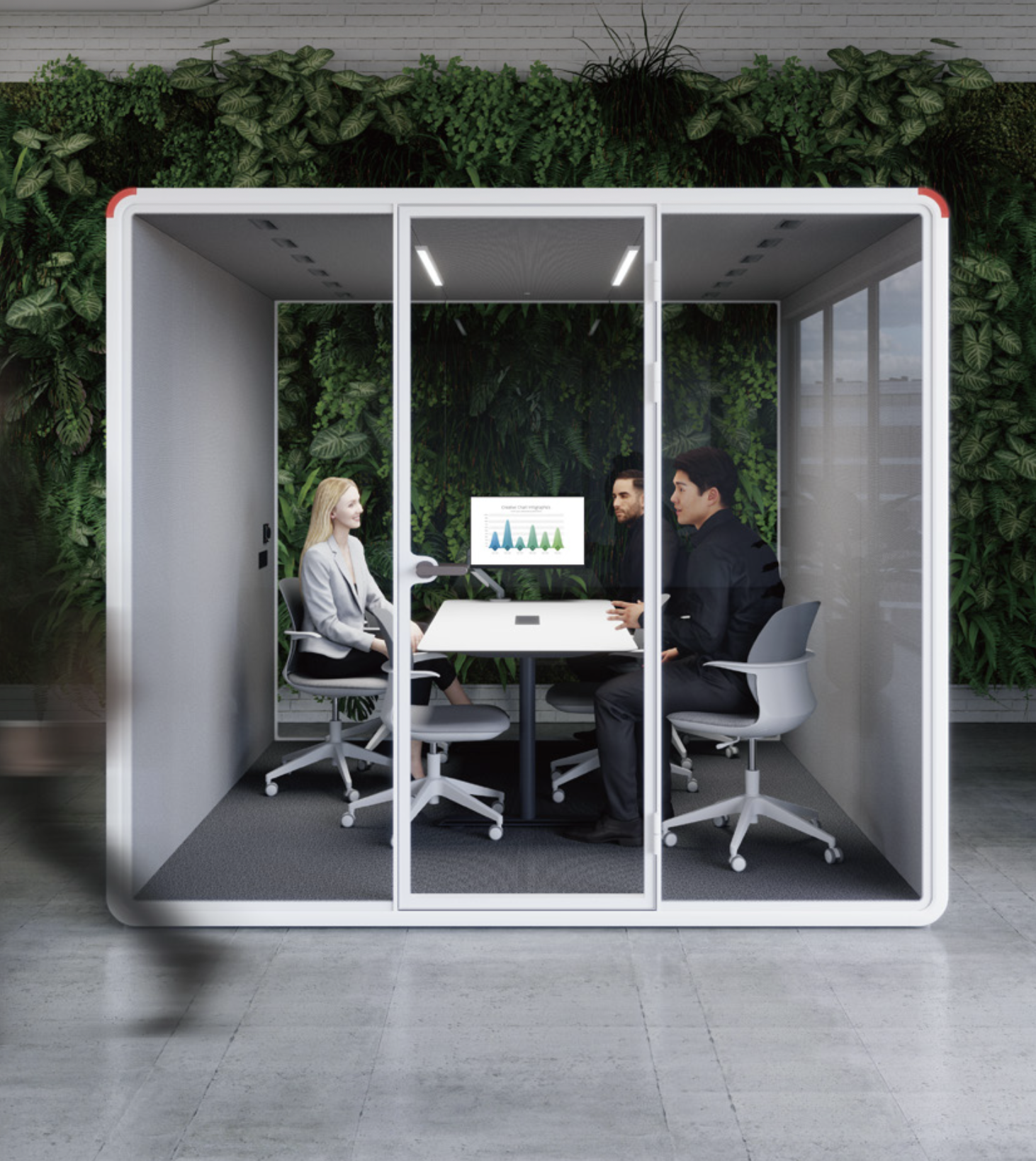 Three people seated inside a modern glass meeting room with green wall background, engaged in a discussion near a table with a monitor displaying graphs.