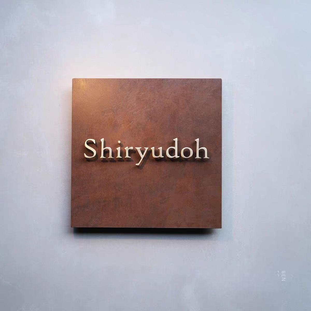 Wall plaque with the name 'Shiryudoh' in metallic letters on a brown rectangular background.