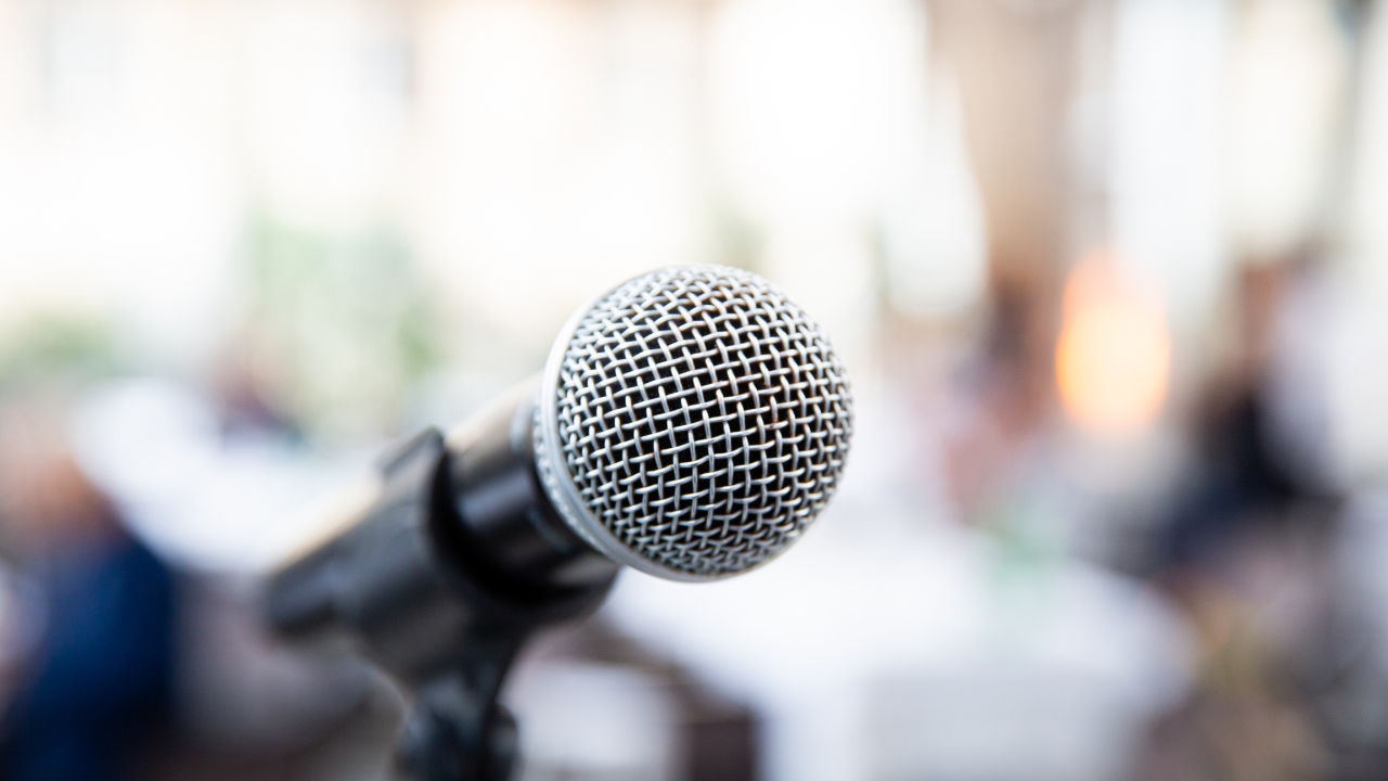 Close up photo of a microphone with a blurred background.