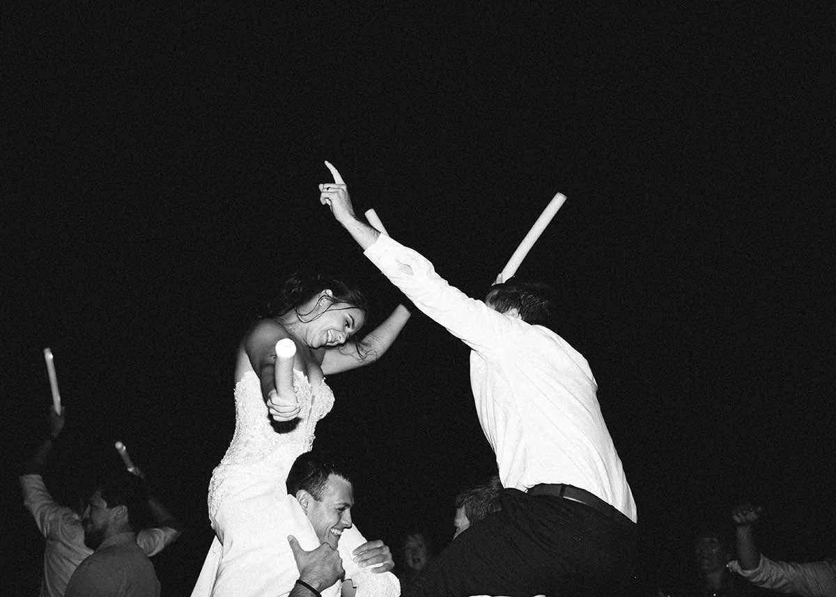 Bride and groom celebrating and dancing at Montana wedding reception after dark
