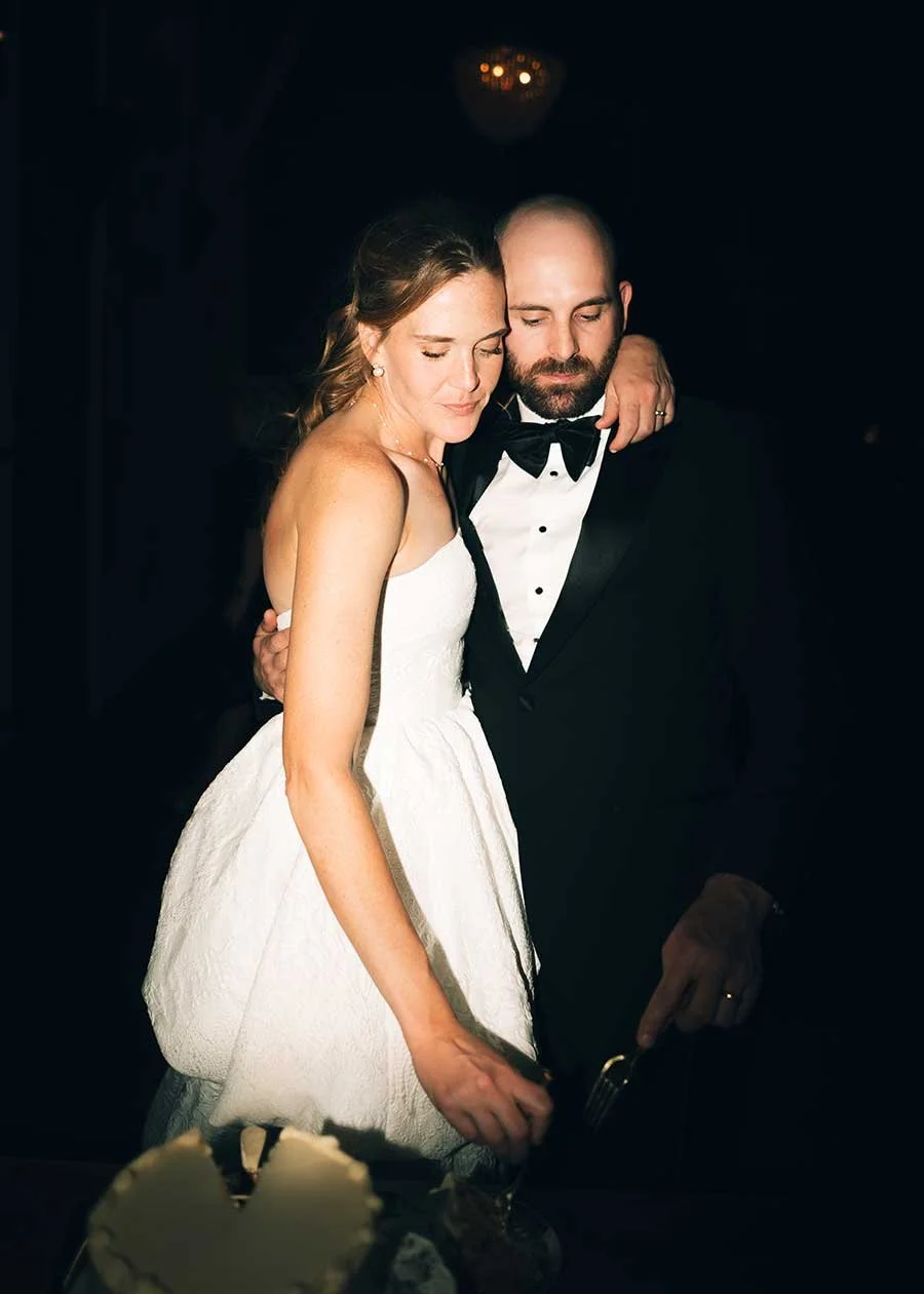A Montana bride and groom sharing an intimate moment at their wedding reception, with closed eyes and embracing each other.