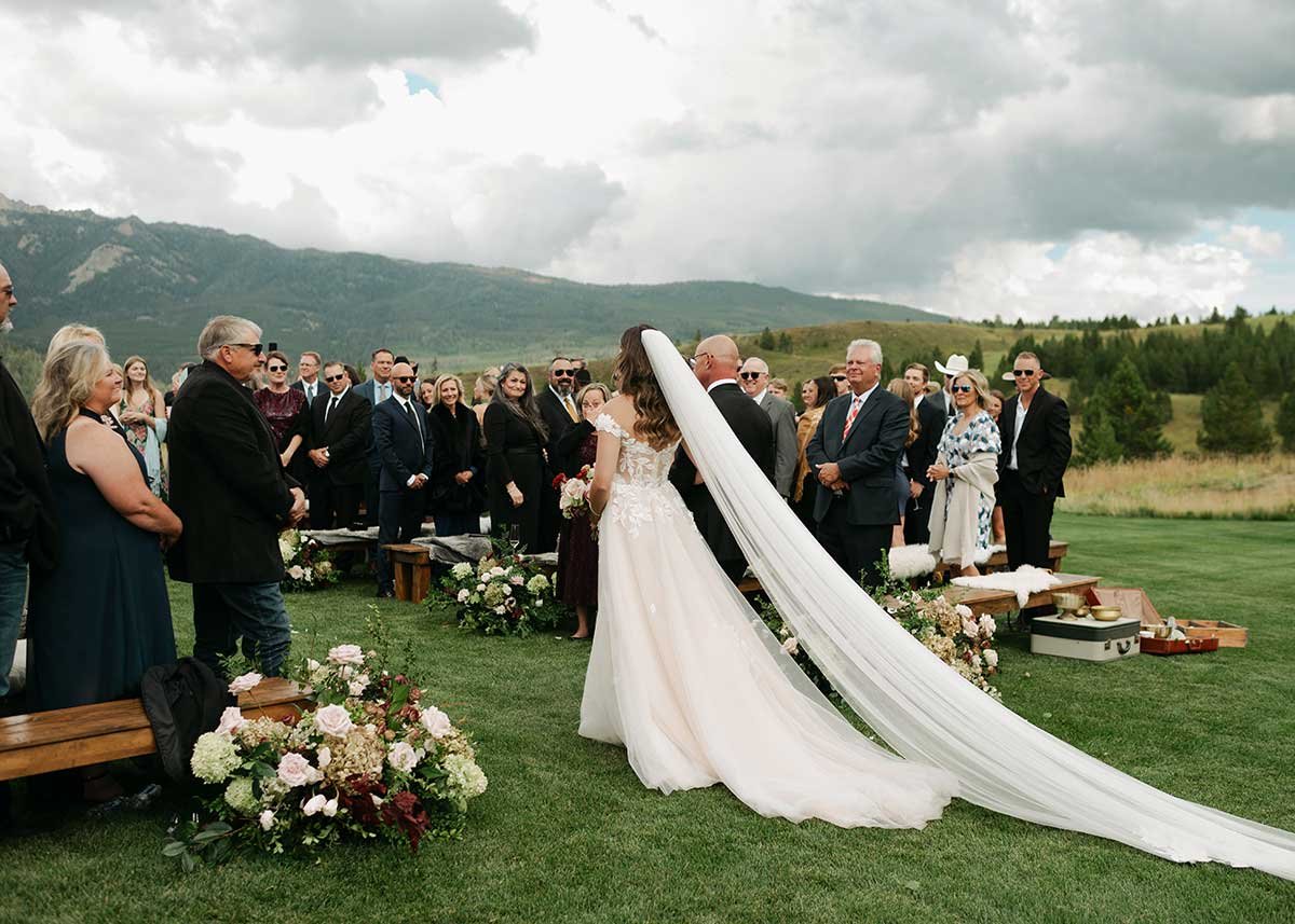 Bride walking down the isle at Montana outdoor wedding