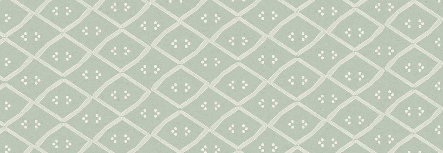 Close-up of a patterned fabric with a light green background and a diamond lattice design, featuring small white four-petal flower motifs inside each diamond.