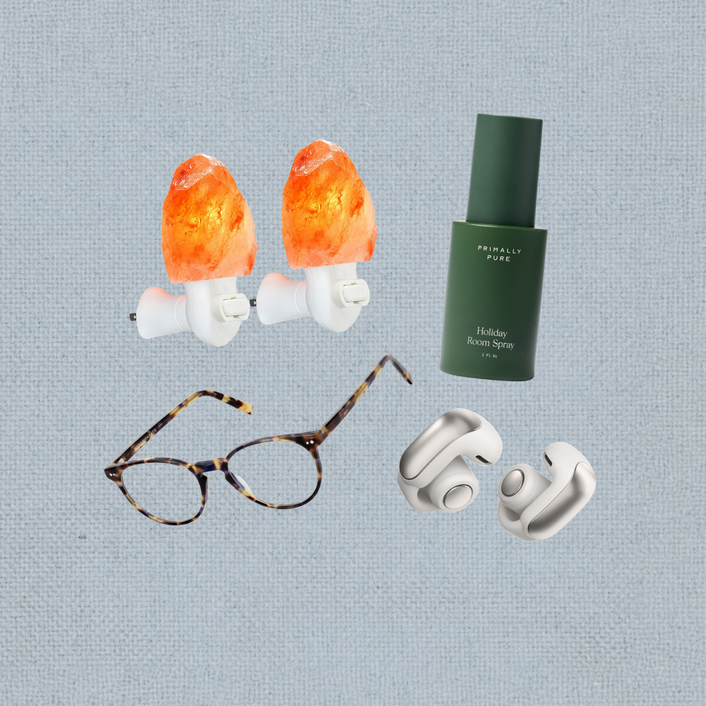 Salt lamp night lights, green room spray, tortoiseshell glasses, and wireless earbuds on a textured light gray background.