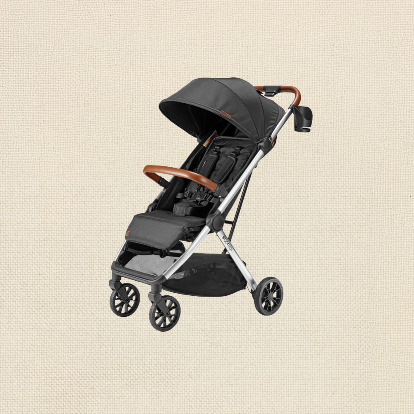 A black baby stroller with brown accents, featuring a canopy, built-in harness, and storage basket underneath, set against a beige textured background.