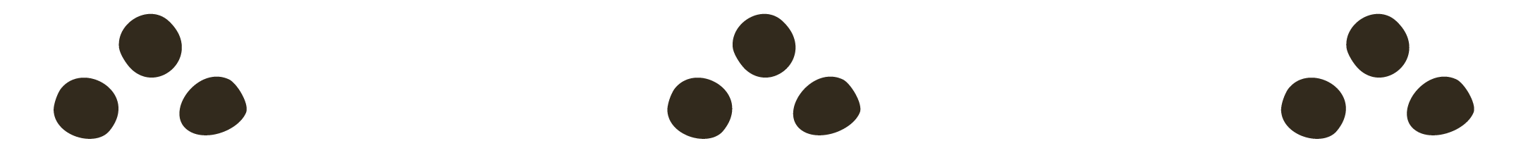 Close-up of three dots placed in a triangle shape on a white background