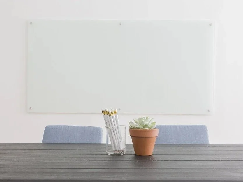 Table  and a blank whiteboard on the wall.