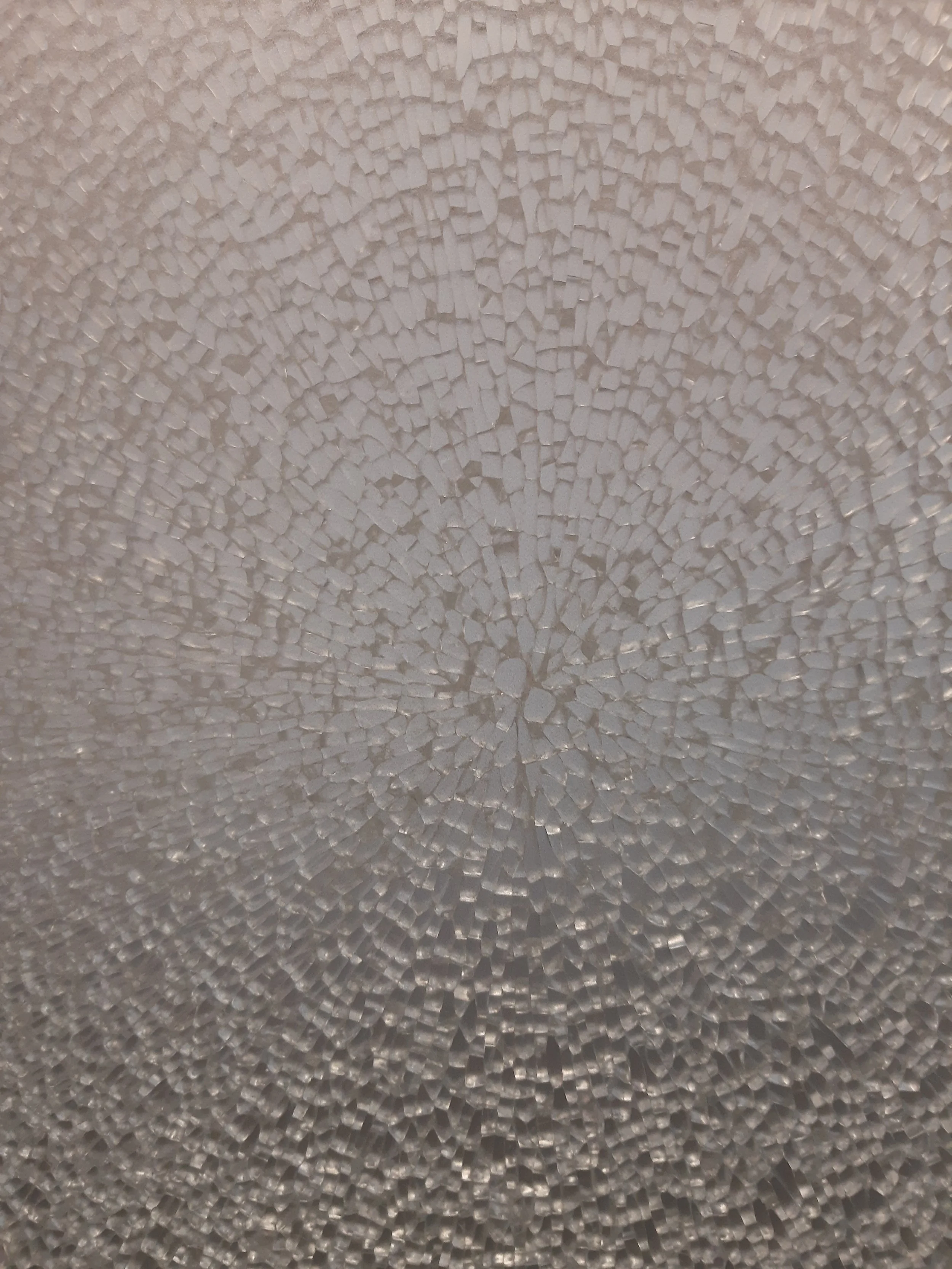 Close-up of a textured, cracked ice surface with a circular pattern.