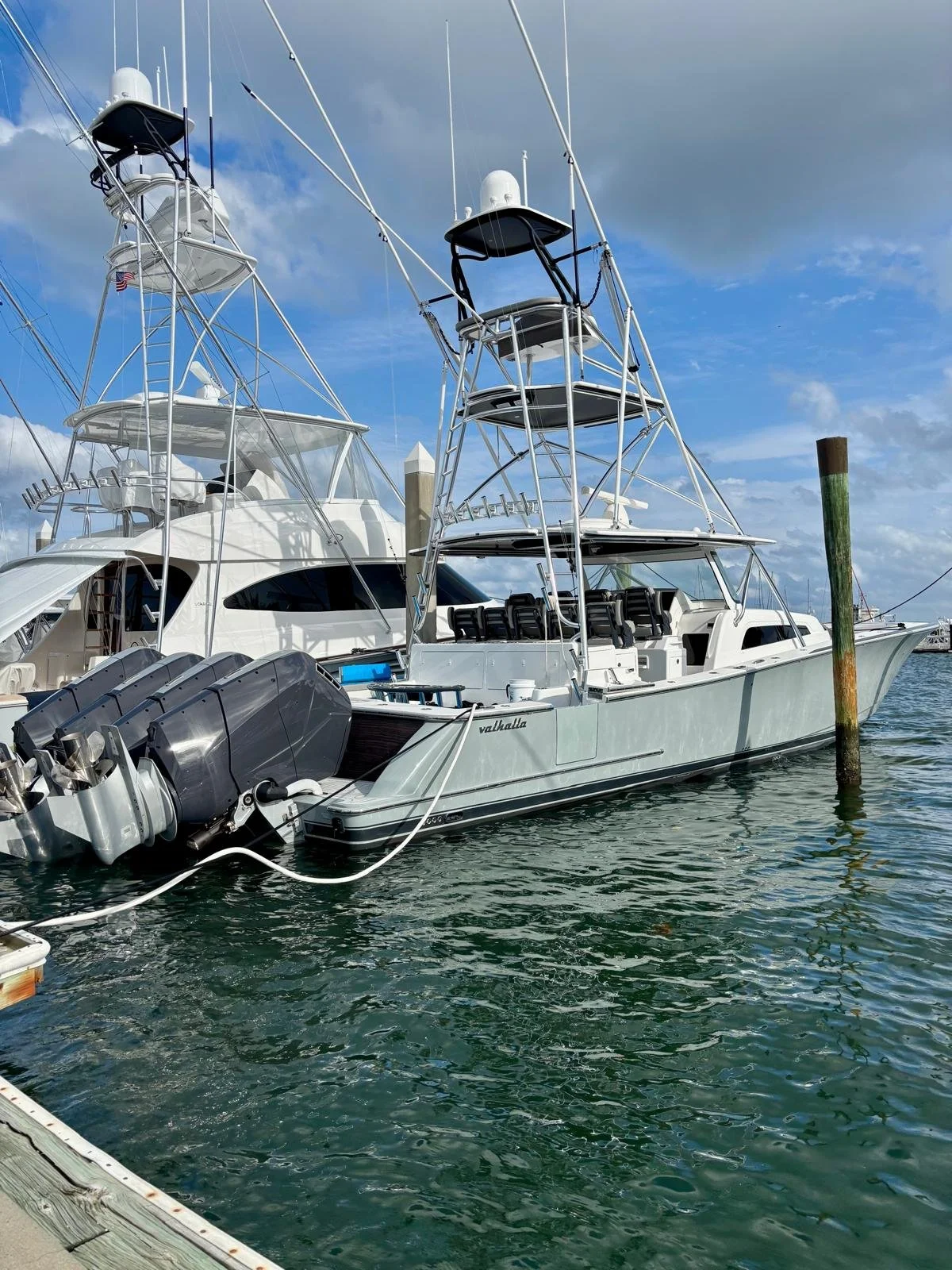 Fully detailed boat exterior with a polished hull reflecting the marina