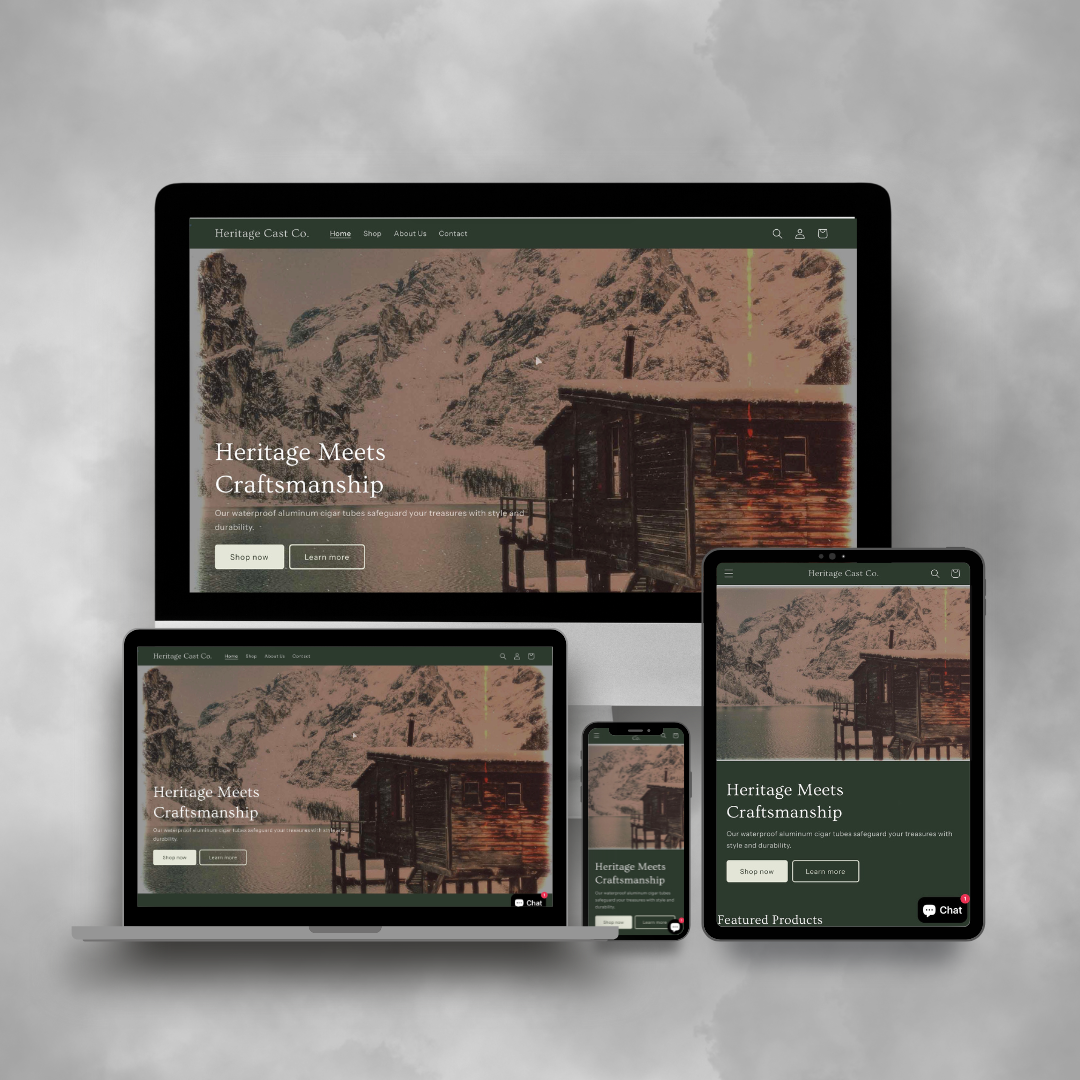 Website displayed on multiple screens including desktop, laptop, tablet, and smartphone. The website belongs to Heritage Cast Co. and features a background image of a cabin by a lake with snow-covered mountains in the distance. The text on the site reads "Heritage Meets Craftsmanship" with options to shop or learn more.